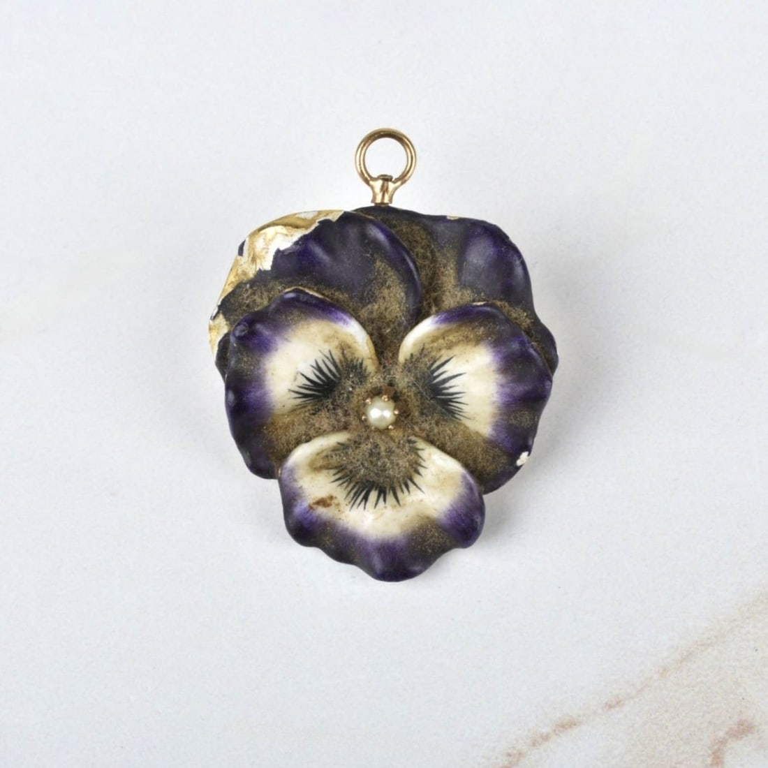 Enamel and 14K Pansy Pendant: Antique Art Nouveau Enamel and 14 Karat Yellow Gold Pansy Pendant / Brooch with Seed Pearl to Center. Measures 1-3/8" H, 1" W. Approx. weight: 8.07 grams. Kodner Galleries offers phone and absentee