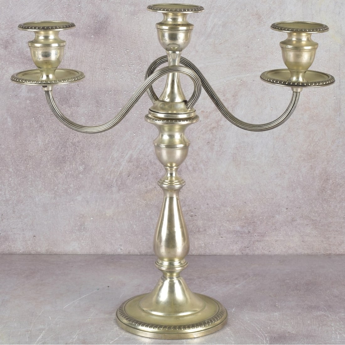 Mueck-Cary Sterling Silver Candelabra: Mueck-Cary N.Y. Reinforced Sterling Silver 3-Light Candelabra. Arms are removable allowing use as single candlestick. Hallmarked, marked sterling and numbered "26" to underside. Measures: 13-1/4"
