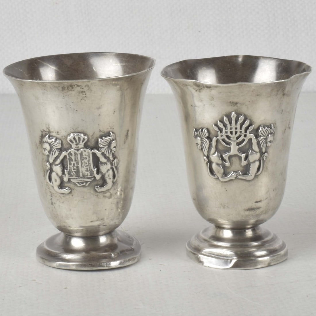 Judaica Sterling Silver Kurdish Cups: Two (2) Antique Judaica Sterling Silver Kurdish Cups. Each marked "STERLING" to the underside. Measures: 3-1/2" high. Total approximate weight:: 3.43 troy ounces. Kodner Galleries offers phone and