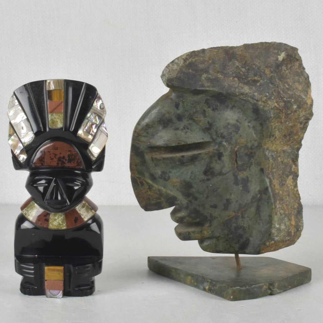 Mayan Aztec Sculptures: Collection of Two (2) Mayan Aztec Sculptures. Consisting of one (1) standing figure with inlay stone and shell, measures: 6-3/8" high, 2-3/4" wide, 2-5/8" deep, one (1) green stone Mayan head figure