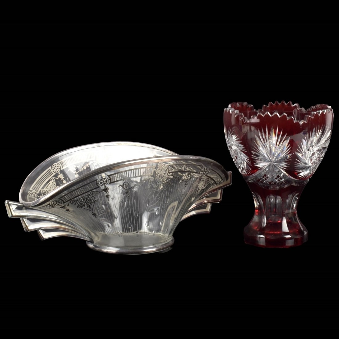 Glass Table Ware Pieces: Two (2) Glass Table Ware Pieces. Consisting of one (1) Bohemian cut crystal cranberry to clear bowl. Measures: 7-3/4" high, 6" diameter, one (1) oval silver overlay fruit bowl, measures: 5-1/2" high,
