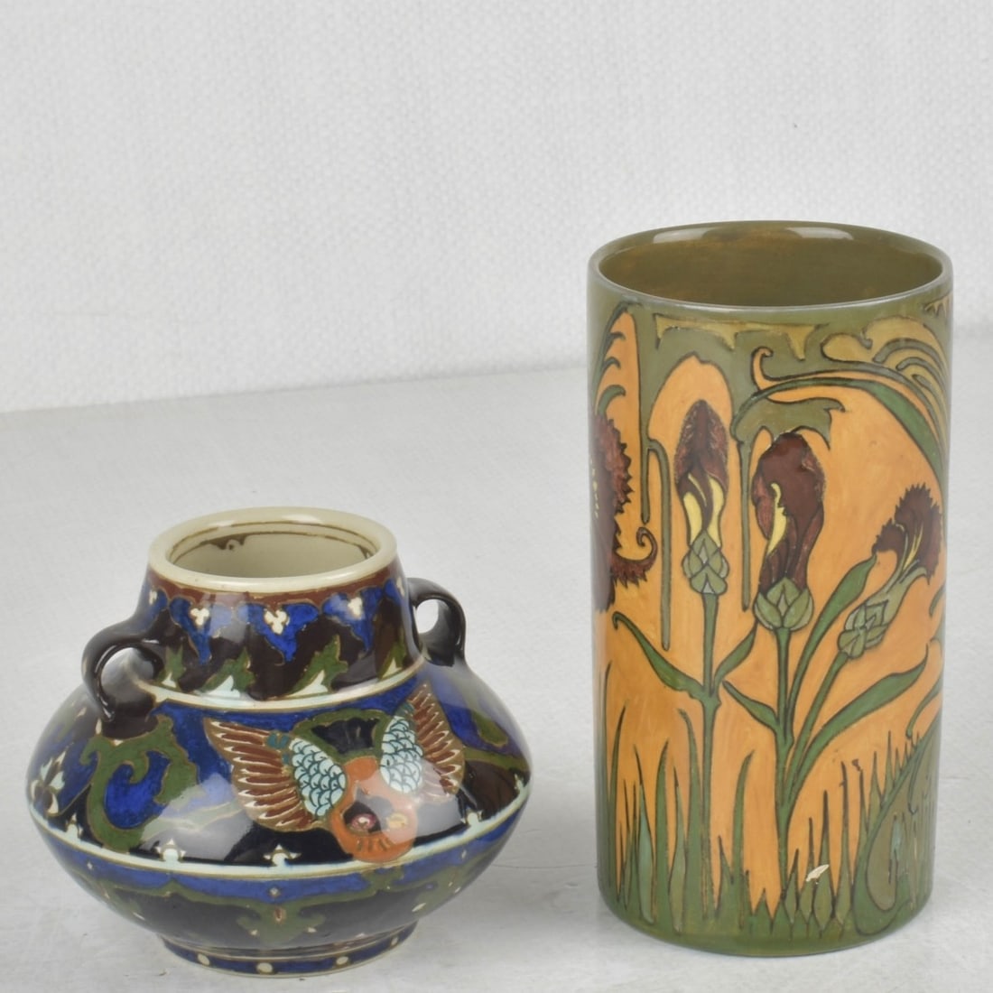 Art Nouveau Rozenburg den Haag Vases: Art Nouveau Two (2) Rozenburg den Haag Dutch Glazed Pottery Vases. Circa 1900. Both Artist signed and numbered to the bottoms. One (1) cylindrical vase. Measures: 4-3/4" high, 2-5/8" diameter, one