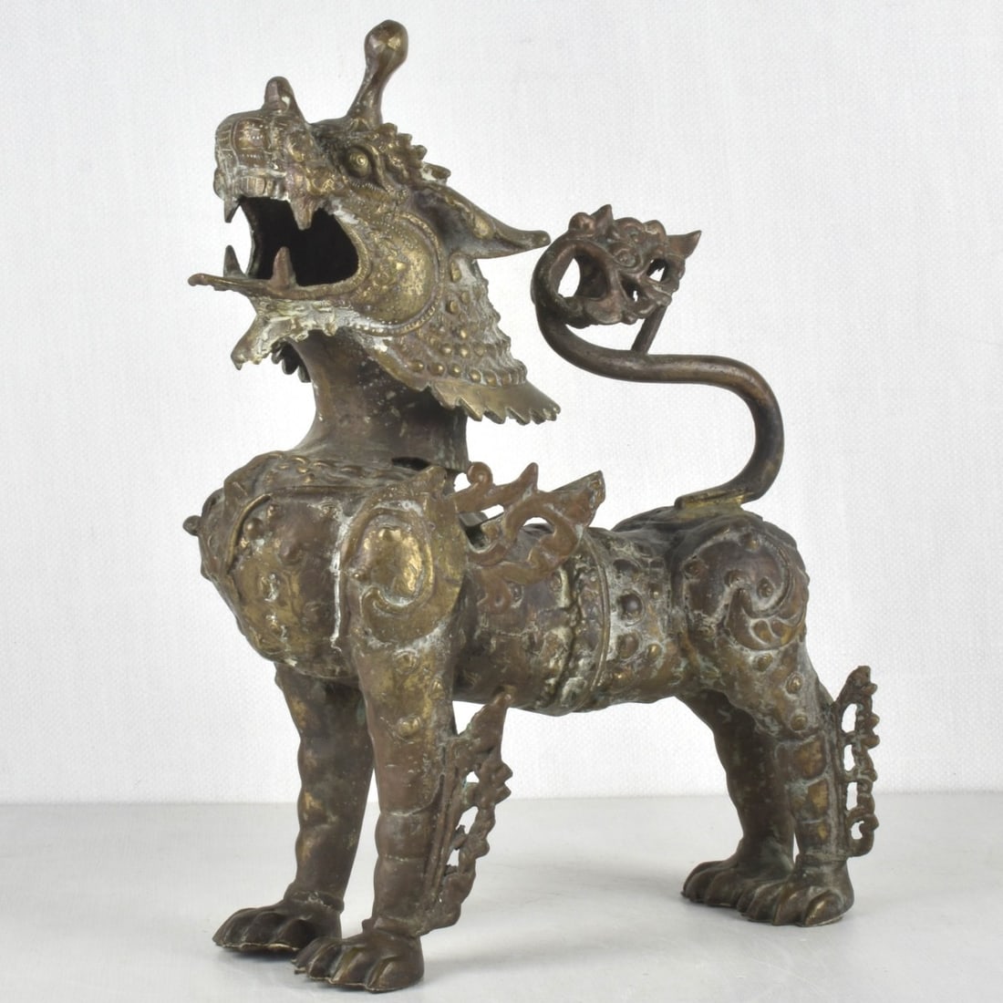 Chinese Bronze Guardian Lion: Early 20th Century Chinese Bronze Guardian Lion. Measures 16-1/2" H, 13" L, 7-1/2" W. Kodner Galleries offers phone and absentee bidding at a low, flat 21% buyer?s premium without surcharge or hidden