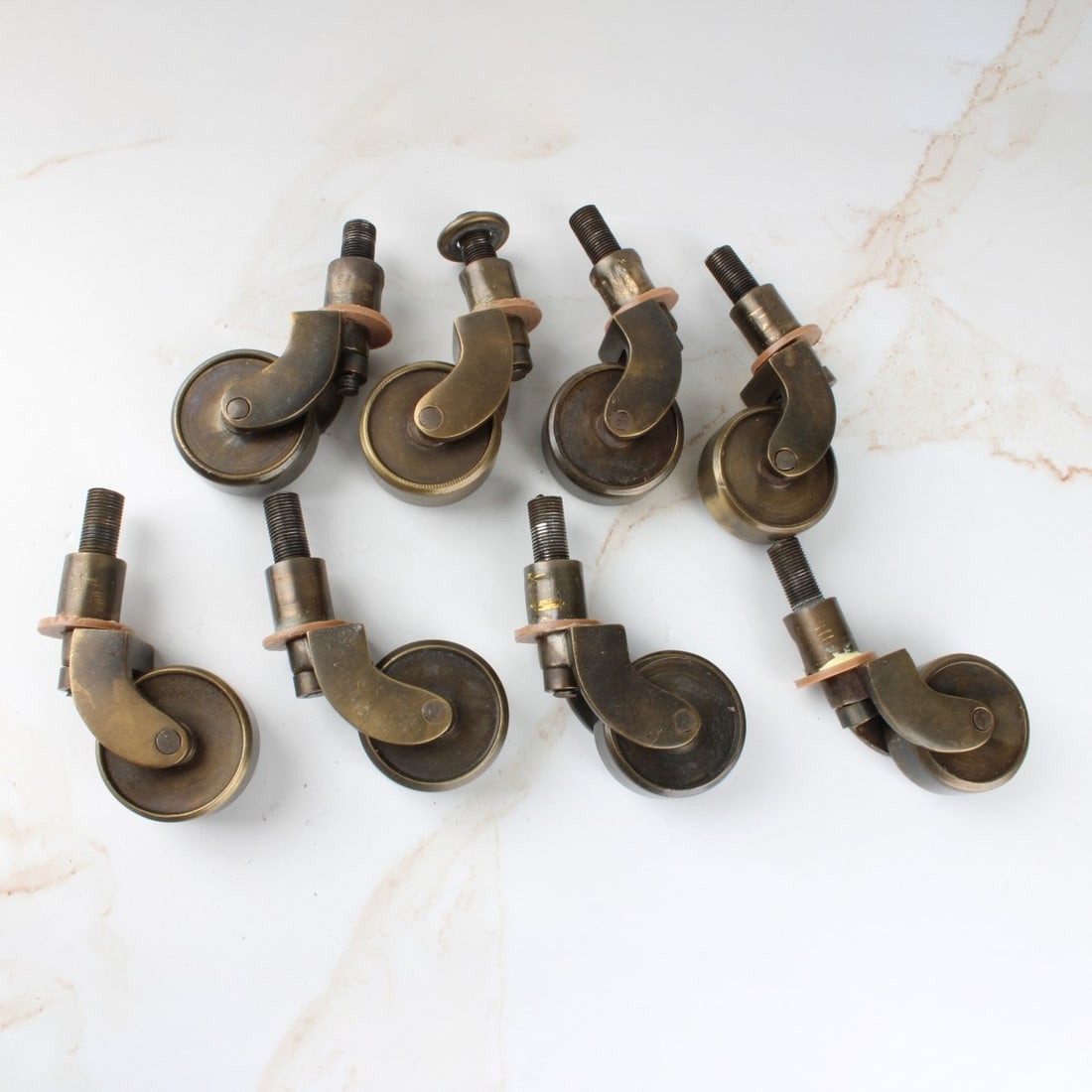 Antique Brass Furniture Casters: Eight (8) Antique Brass Furniture Casters with Threaded Screw. Wheels measures: 1-1/2" diameter, 2" high. Kodner Galleries offers phone and absentee bidding at a low, flat 21% buyer?s premium without