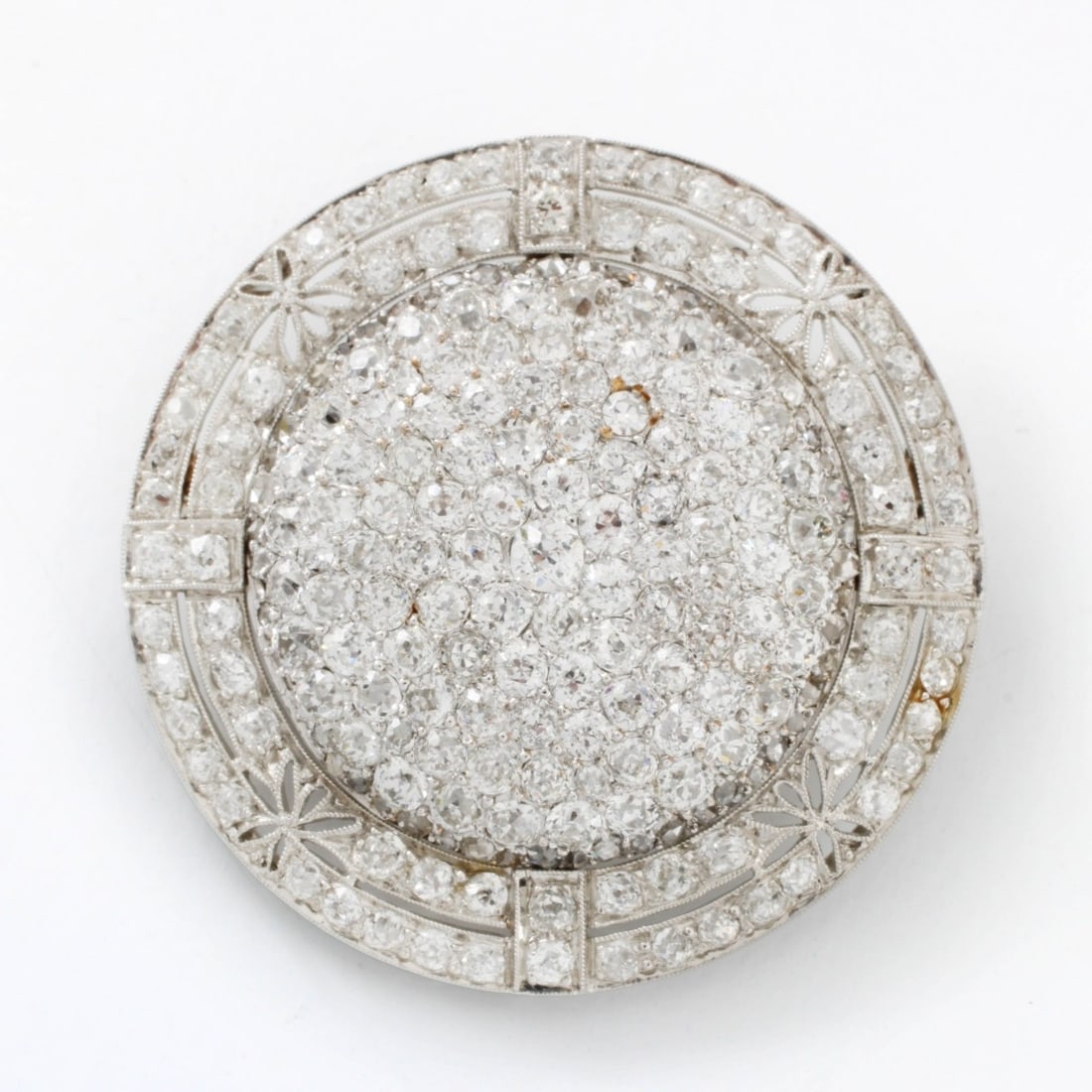 Deco Diamond & Platinum Pendant / Brooch: Fine Art Deco Pave Set Old European Cut Diamond and Platinum Pendant Brooch. Diamonds E-F color, VS clarity. Measures 1-3/8" diam. Approx. weight: 12.39 grams. Kodner Galleries offers phone and absent