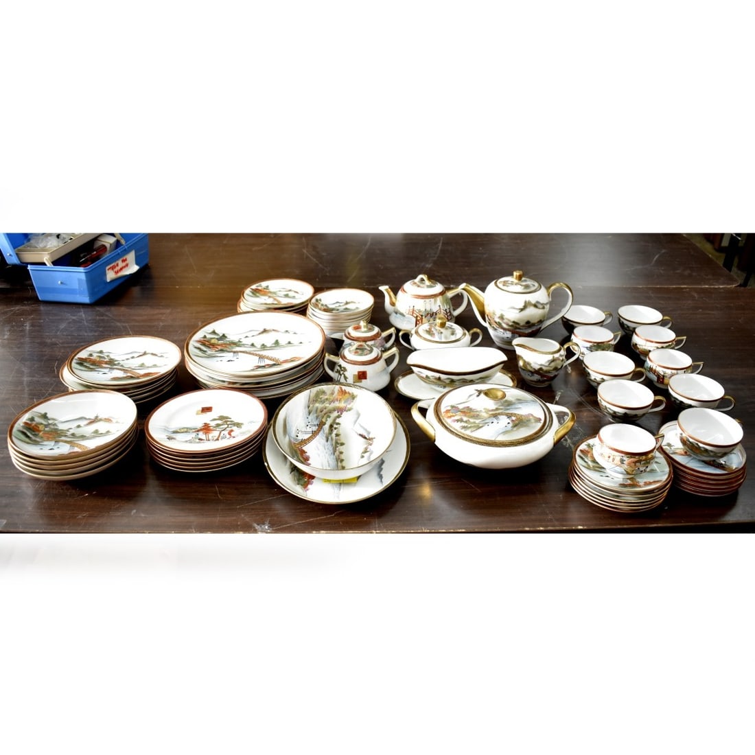 Japanese Satsuma Dinner Service: Sixty Six (66) Piece Vintage Japanese Satsuma Assembled Porcelain Dinner Service, with Bridge and Mt. Fuji. To Include: (6) plates measuring 10-1/4", (6) salad plates 8", (6) bread plates, (6) desert 