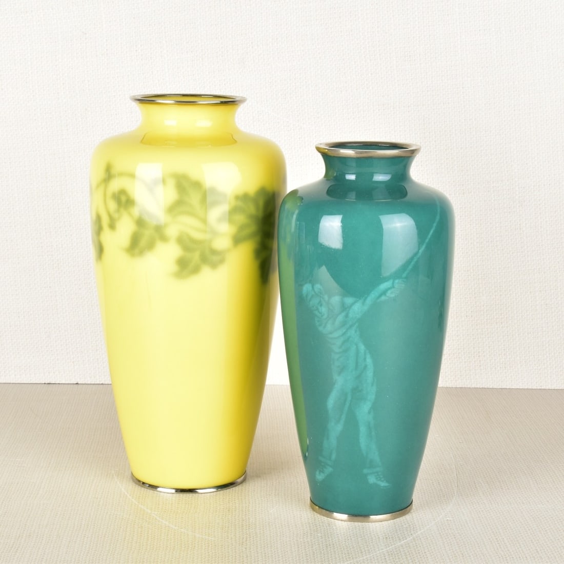 Japanese Wireless Cloisonne Vases: Two (2) Japanese Wireless Cloisonne Vases. One (1) jade green vase decorated with a golfer with chrome top and bottom mounts, stamped "Sato". Circa 1940. Measures: 8-5/16" H, 4" dia. One (1) bright ye