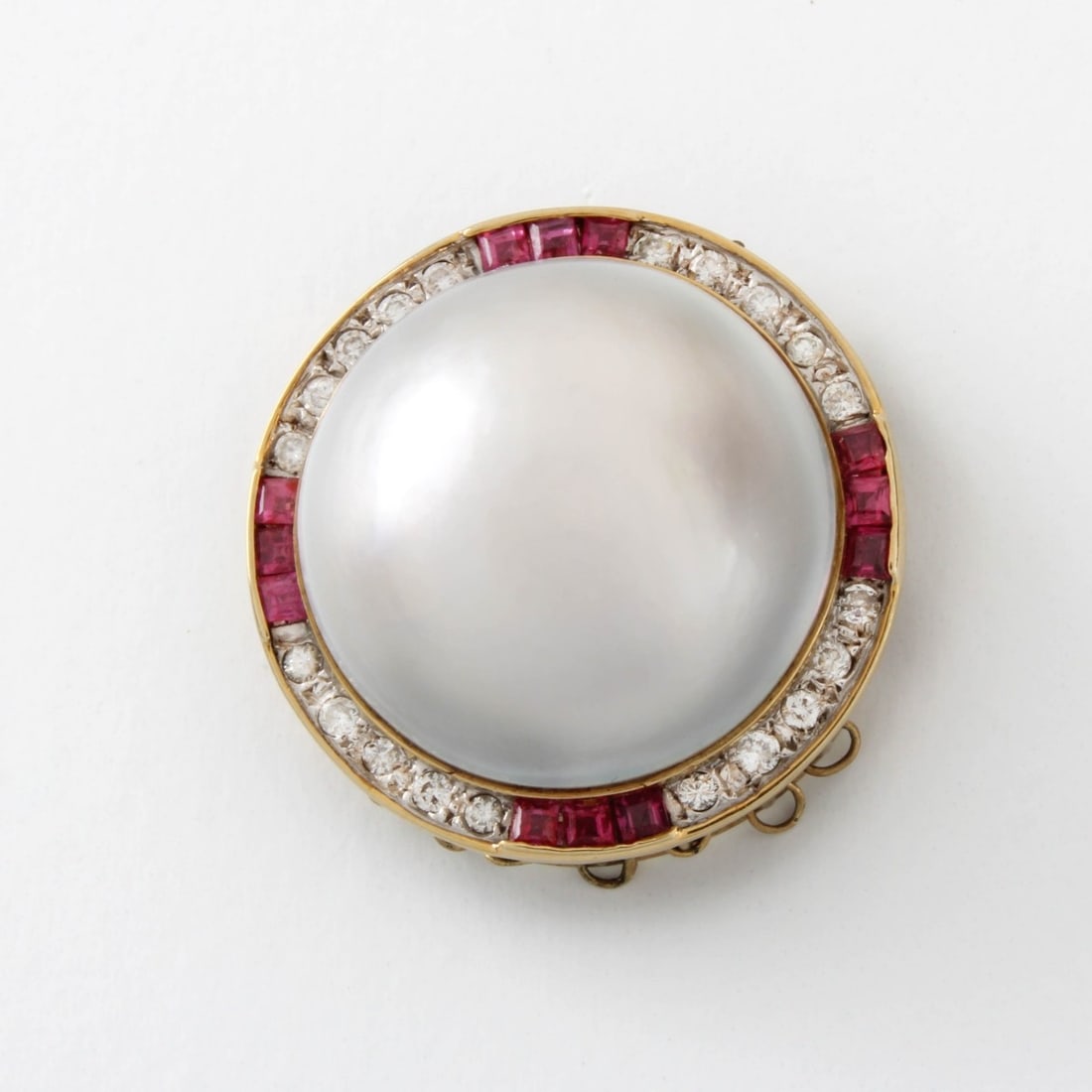 Pearl, Diamond, Ruby and 14K Pendant: Vintage Large Mabe Pear, Round Brilliant Cut Diamond, Baguette Cut Ruby and 14 Karat Yellow Gold Pendant. Pearl with good polish and luster. Diamonds G-H color, VS clarity. Measures 1" diam. Approx. w