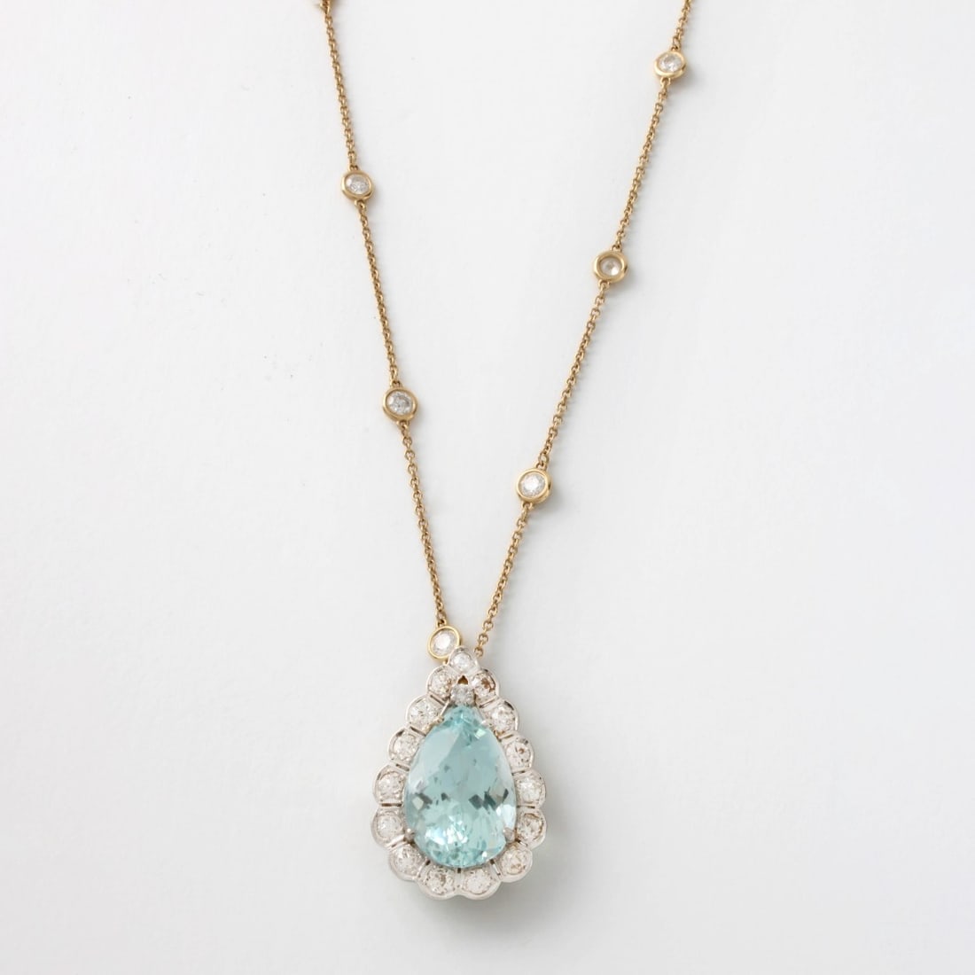 14 KW Gold, Aqua. & Dia. Pendant/Necklace: 14 KW Gold, Aquamarine and Diamond Pendant with a Diamond by the Yard Necklace. Pendant aquamarine 13.63 ct. pear shape with 1.50 ct. diamonds H-I color, SI/I1 clarity, measures approximately 28mm x 1