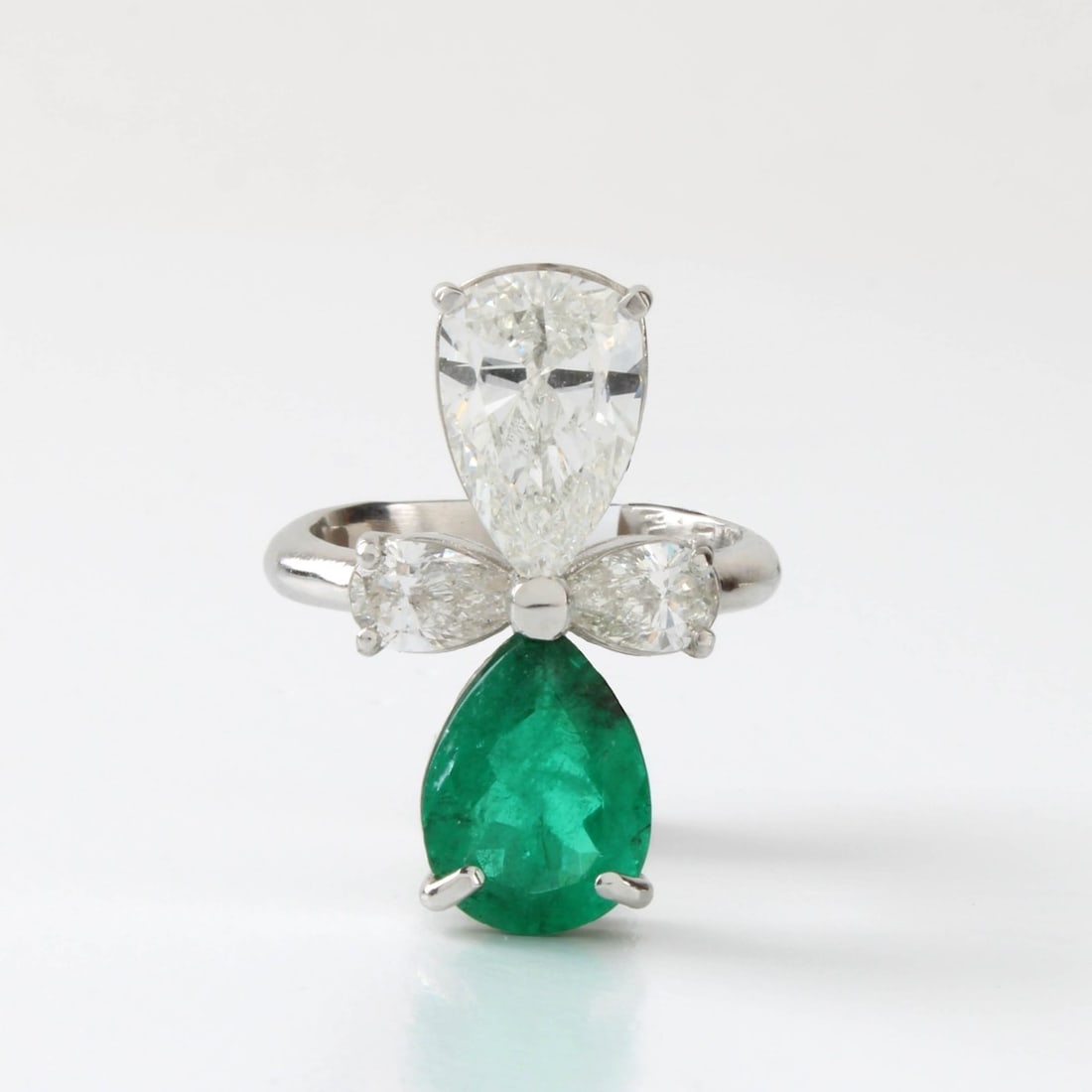 Platinum, Diamond and Emerald Ring: Platinum, Diamond and Emerald Ring. Larger pear shape diamond 2.51 ct. G-H in color, SI2 in clarity, pear shape emerald 2.67 ct. 2 smaller diamonds 1.01tw G-H in color, VS-SI in clarity. Size 6-1/2. A