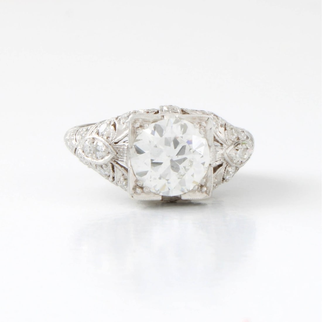 Art Deco Platinum and Diamond Ring: Art Deco Platinum and Diamond Ring. Set in the center with a 1.80 carat round brilliant G in color VS2 clarity, 20 round brilliant cut 0.80 ctw G-H in color VS-SI in clarity. Ring measures: 3.8" side,