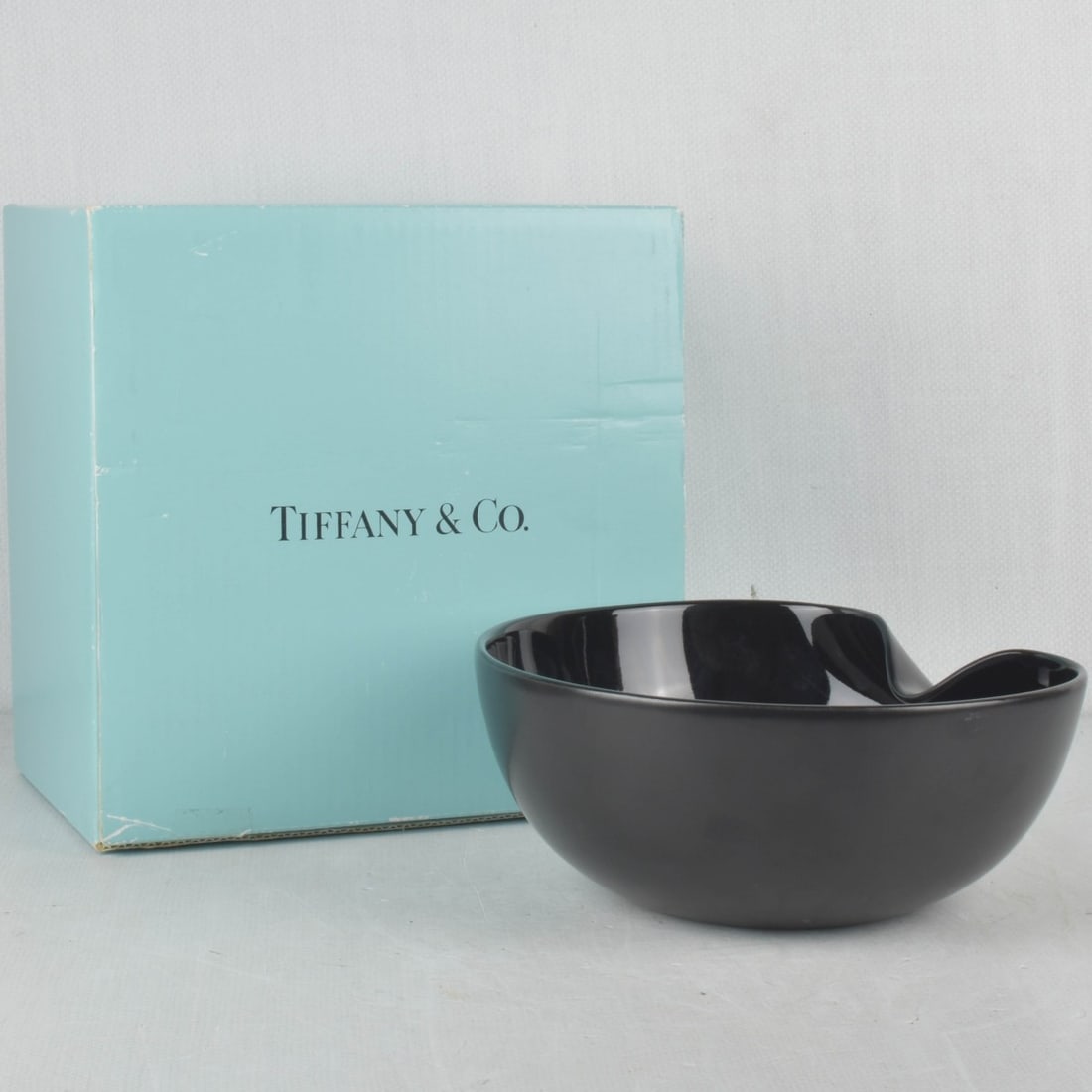 Elsa Peretti for Tiffany & Co: Vintage Black Ceramic Thumbprint Bowl Crafted by Elsa Peretti for Tiffany & Co. Signed on the underside. Matte black exterior, glossy glazed interior. With original box. Measures: 3-7/8" high, 9" diam