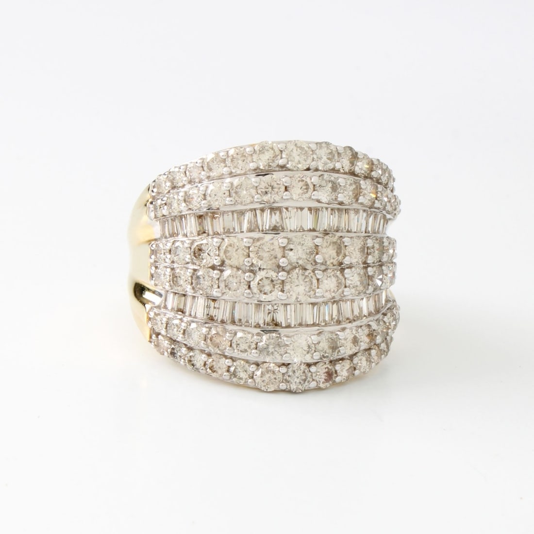 Diamond and 10K Ring: Vintage Approx. 4.0 Carat TW Round Brilliant and Baguette Cut Diamond and 10 Karat Yellow Gold Cluster Ring. Diamonds G-H color, VS1-VS2 clarity with a few SI1. Stamped 10K. Ring size 9. Approx. weigh