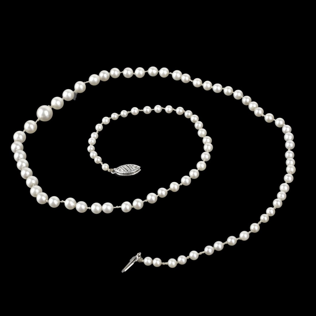 Pearl and 14K Necklace: Antique Single Strand Possibly Natural 3.0-7.8mm Pearl Necklace with 14 Karat White Gold Necklace. Pearls with good luster and polish. Necklace measures 21-3/4" L. Approx. weight: 10.35 grams. Kodner 