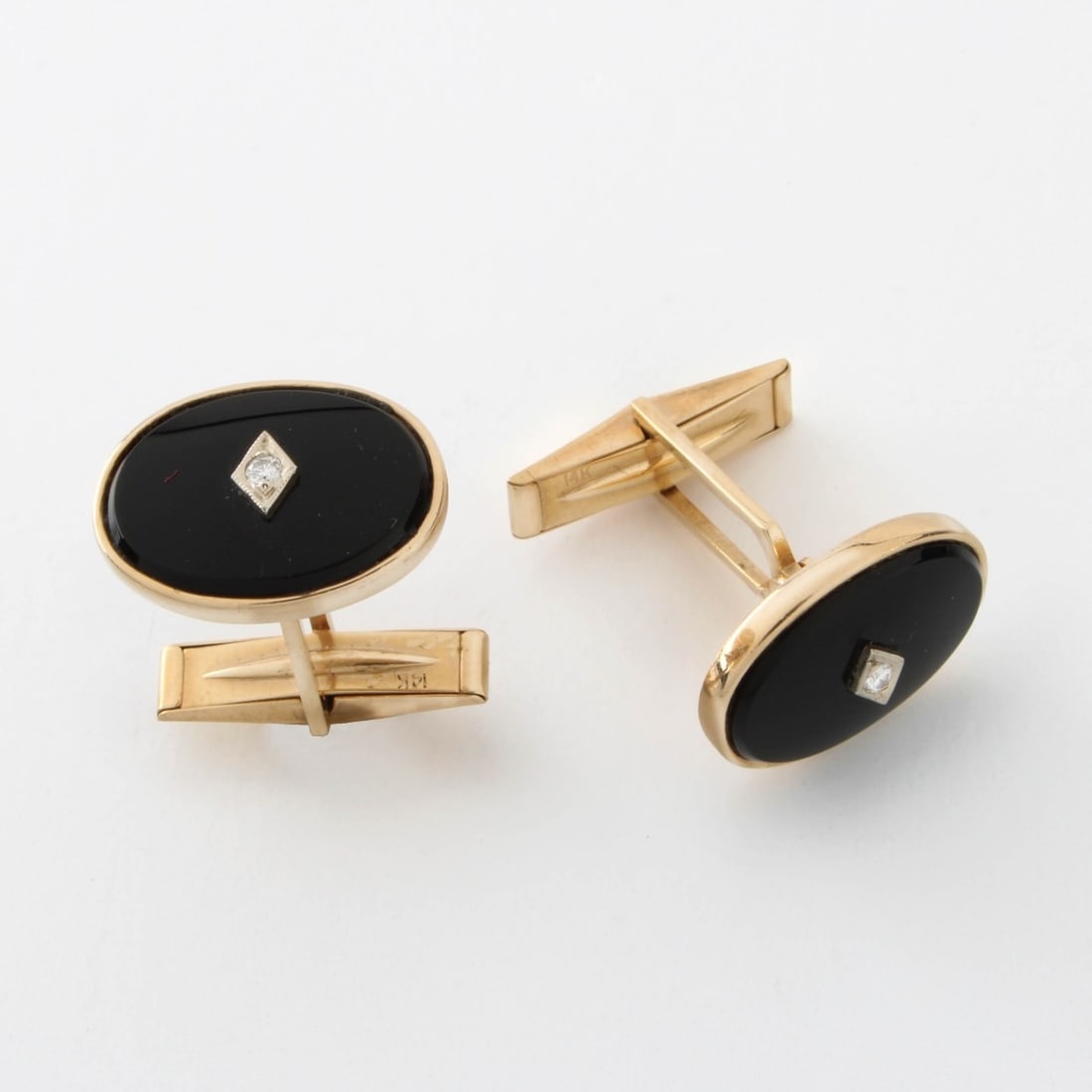 Onyx, Diamond and 14K Cufflinks: Vintage Black Onyx, Round Brilliant Cut Diamond and 14 Karat Yellow Gold Cufflinks. Measure 5/8" x 1/2" Approx. total weight: 8.40 grams. Kodner Galleries offers phone and absentee bidding at a low, f