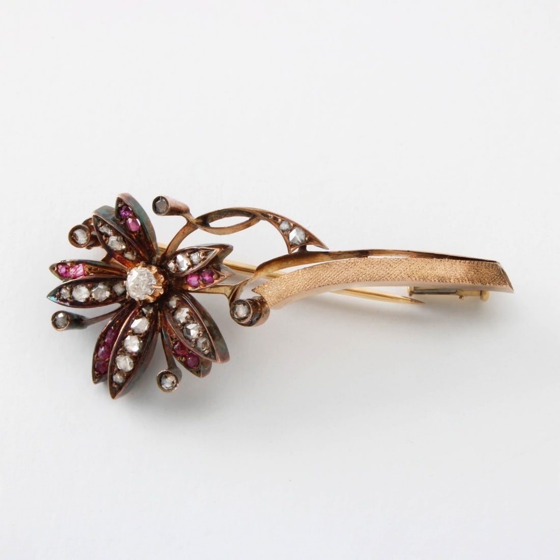 Diamond, Ruby and 14K Brooch: Antique 19th Century Old European and Rose Cut Diamond, Rose Cut Ruby and 14 Karat Yellow Gold Flower Pin. Measures 1-3/4" L, 3/4" W. Approx. weight: 8.20 grams. Kodner Galleries offers phone and abse