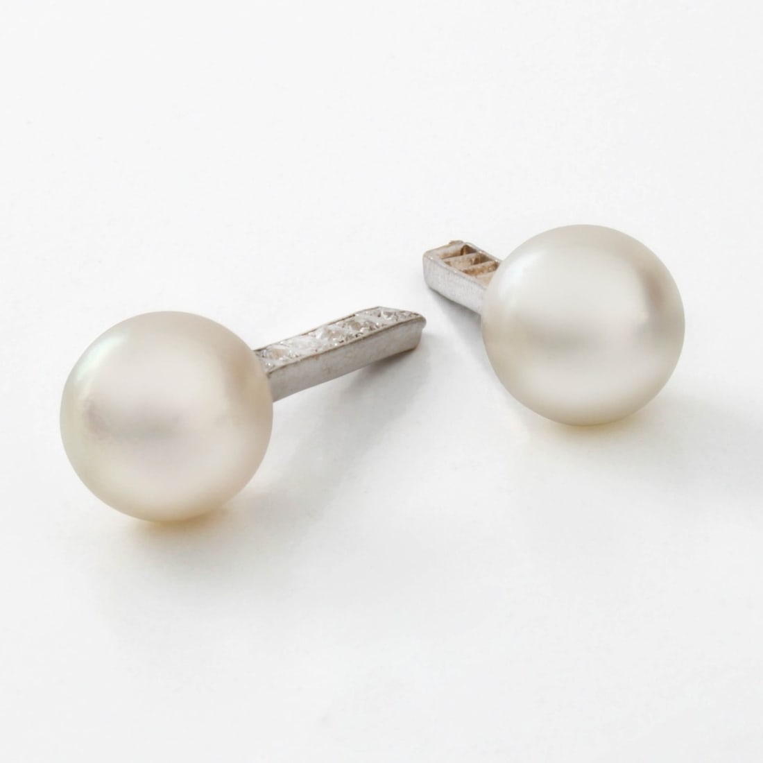 Pearl Ear Stud Enhancers: Vintage 9.25mm Pearl, Old European Cut Diamond and 14 Karat White Gold Ear Stud Enhancers. Pearls with good luster and polish, minor natural blemishes. Overall measure 1" L. Approx. total weight: 4.0 