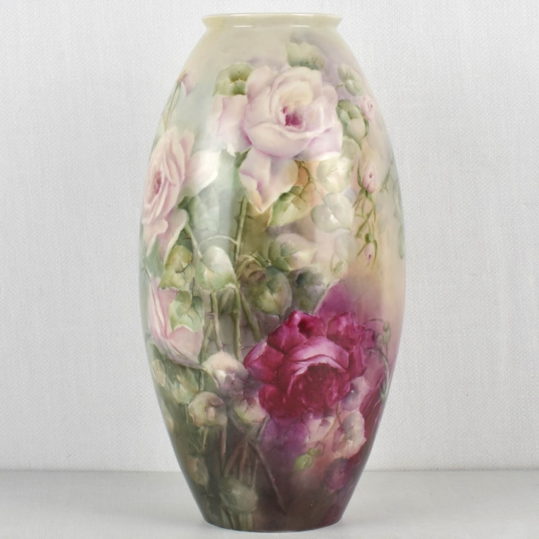Willets American Belleek Porcelain Vase: Willets American Belleek Porcelain Floral Vase. Circa 1900. Signed "L.B. McClure" to the side. Decorated with large roses, leaves and stems on a dark green to light green ground. Bottom marked "BELLEE