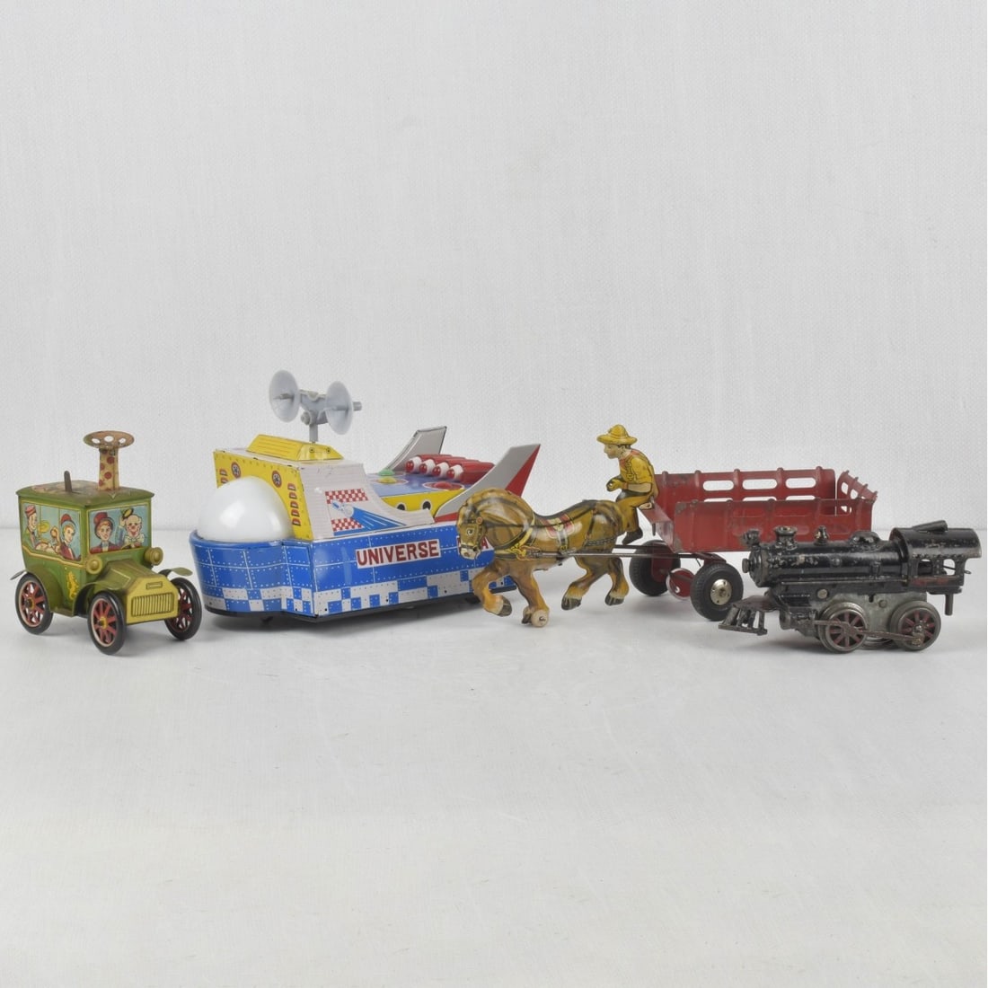 Collection of Four (4) of Antique or Vintage Toys: Collection of Four (4) of Antique or Vintage Toys. Consisting of one (1) antique American Flyer wind up cast iron locomotive circa 1922, measures: 6-3/4" long, one (1) Marx litho tin horse drawn cart 