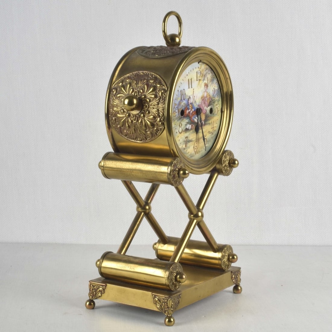 Vintage Brass Mantle Clock: Vintage Brass Mantle Clock with a Painted Romantic Scene on Dial. Measures: 15" high, 7" wide, 5" deep. Kodner Galleries offers phone and absentee bidding at a low, flat 21% buyer?s premium without su