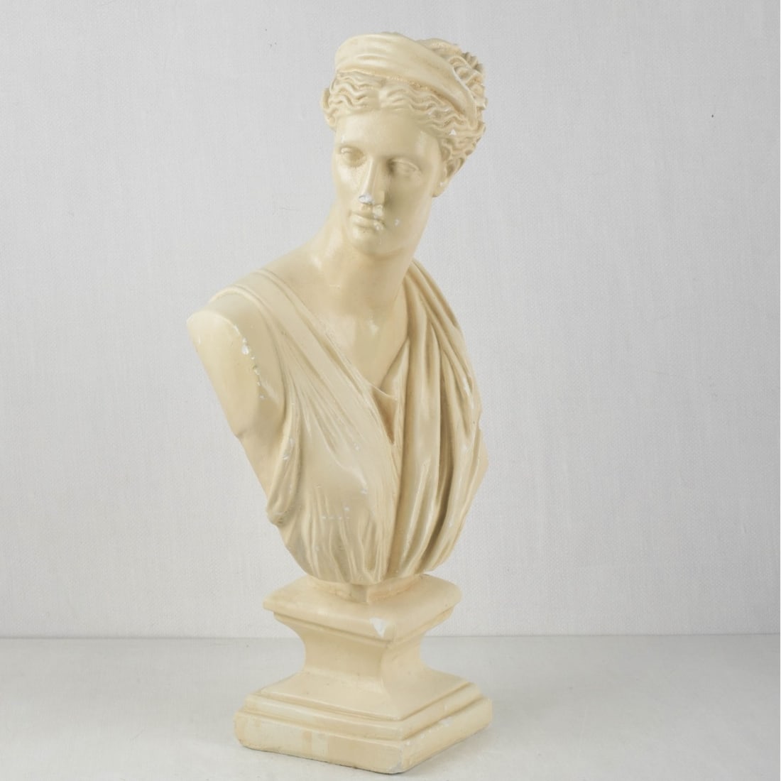 Plaster Bust of a Greek Goddess: Plaster Bust of a Greek Goddess. Overall measures: 22-1/2" high, 11-1/4" wide, 6" deep. Kodner Galleries offers phone and absentee bidding at a low, flat 21% buyer?s premium without surcharge or hidde