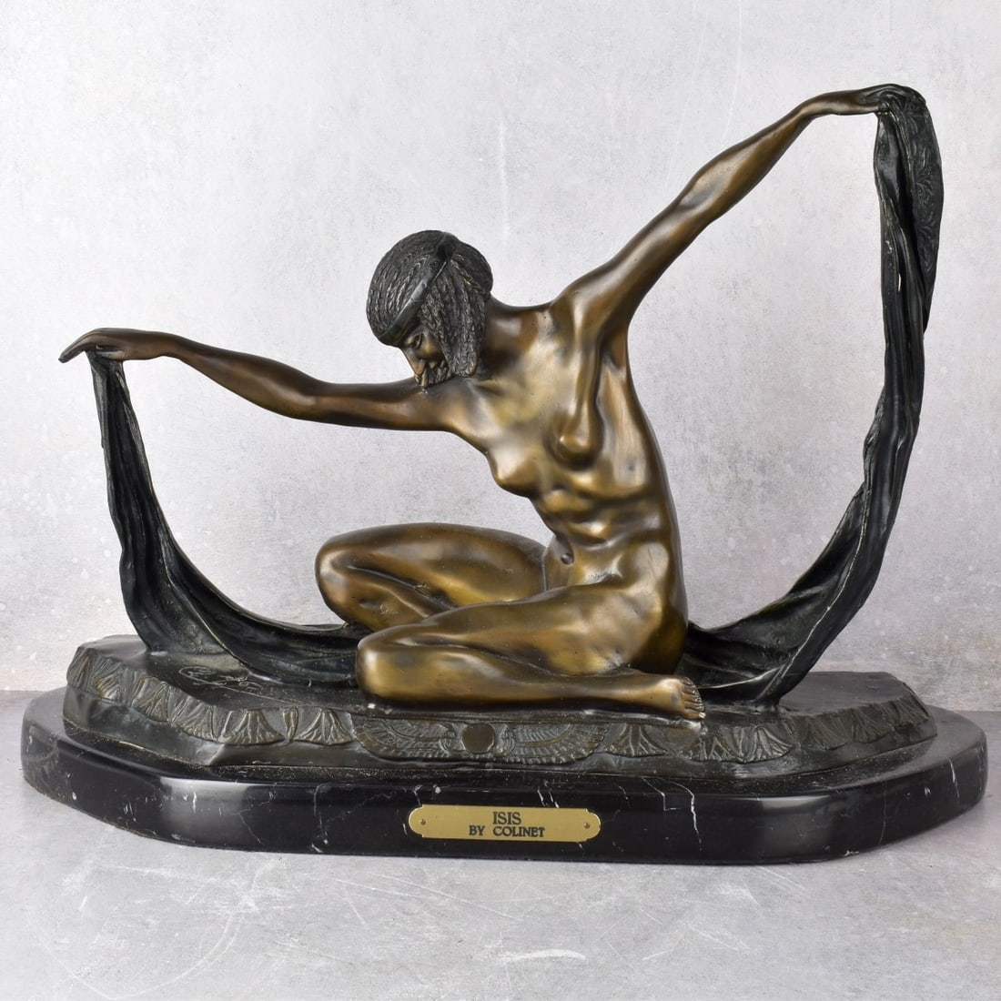 After: Claire Jeanne Roberte Colinet, French: After: Claire Jeanne Roberte Colinet, (French, 1880-1950) "Isis" Bronze Sculpture Mounted to a Black Marble Base. Signed "Cl. J. R. Colinet" with an affixed gold plaque attached at the front reads "Is