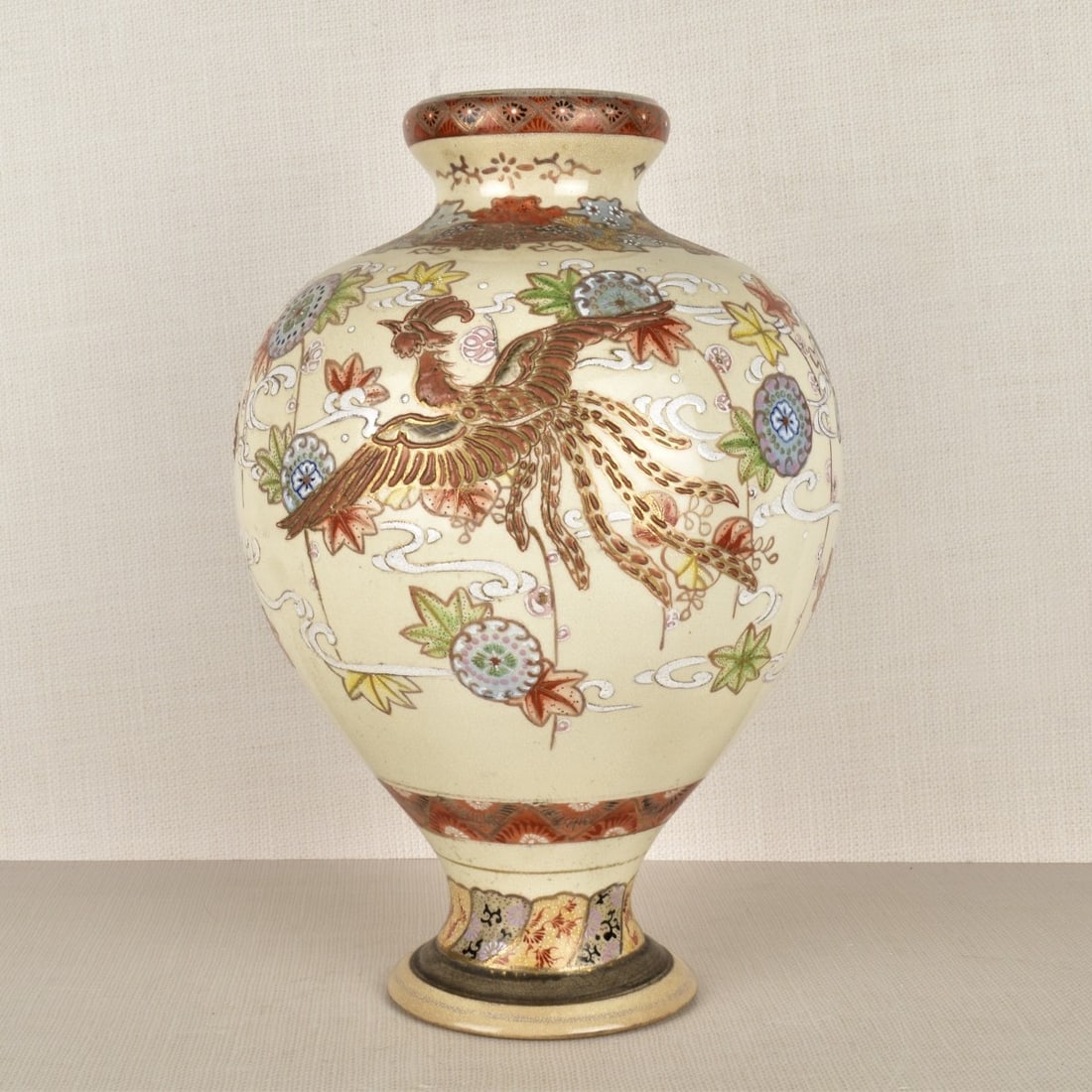 Japanese Pottery Vase: Large Japanese Pottery Ware Bulbous Shape Vase with Heavy Raised Enamel of Foo Dogs and Phoenix all Around. Late 20th century. Measures: 14-1/2" H, 9" W. Kodner Galleries offers phone and absentee bid