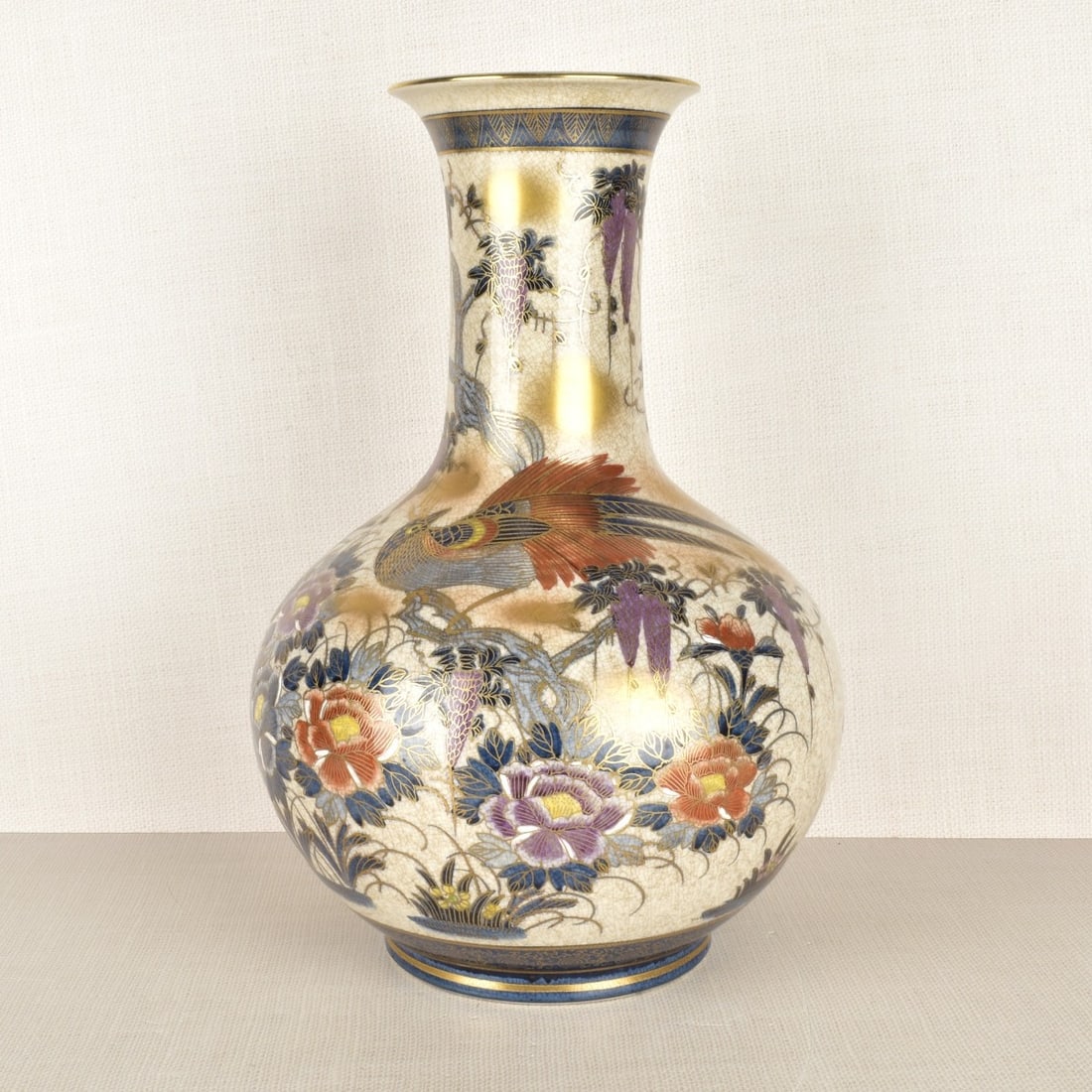 Japanese Satsuma Vase: Japanese Satsuma Bulbous Crackle Vase with Gold Trim and an Inverted rim. Artist signed to the bottom. Measures: 15-1/16" H, 10" dia. 20th century. Kodner Galleries offers phone and absentee bidding a