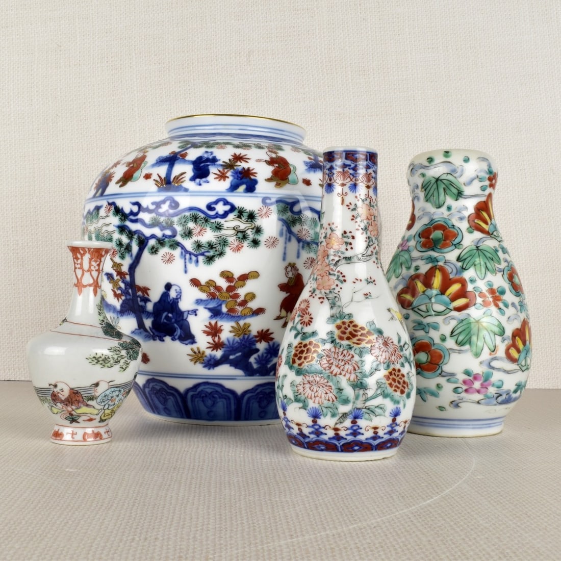 Asian Porcelain Vases: Four (4) Asian Porcelain Vases Painted with Floral Scenes, Smallest and Largest Artist Signed on the Bottoms. 20th century. Largest measures: 7" H, 7-1/2" Dia. Kodner Galleries offers phone and absent