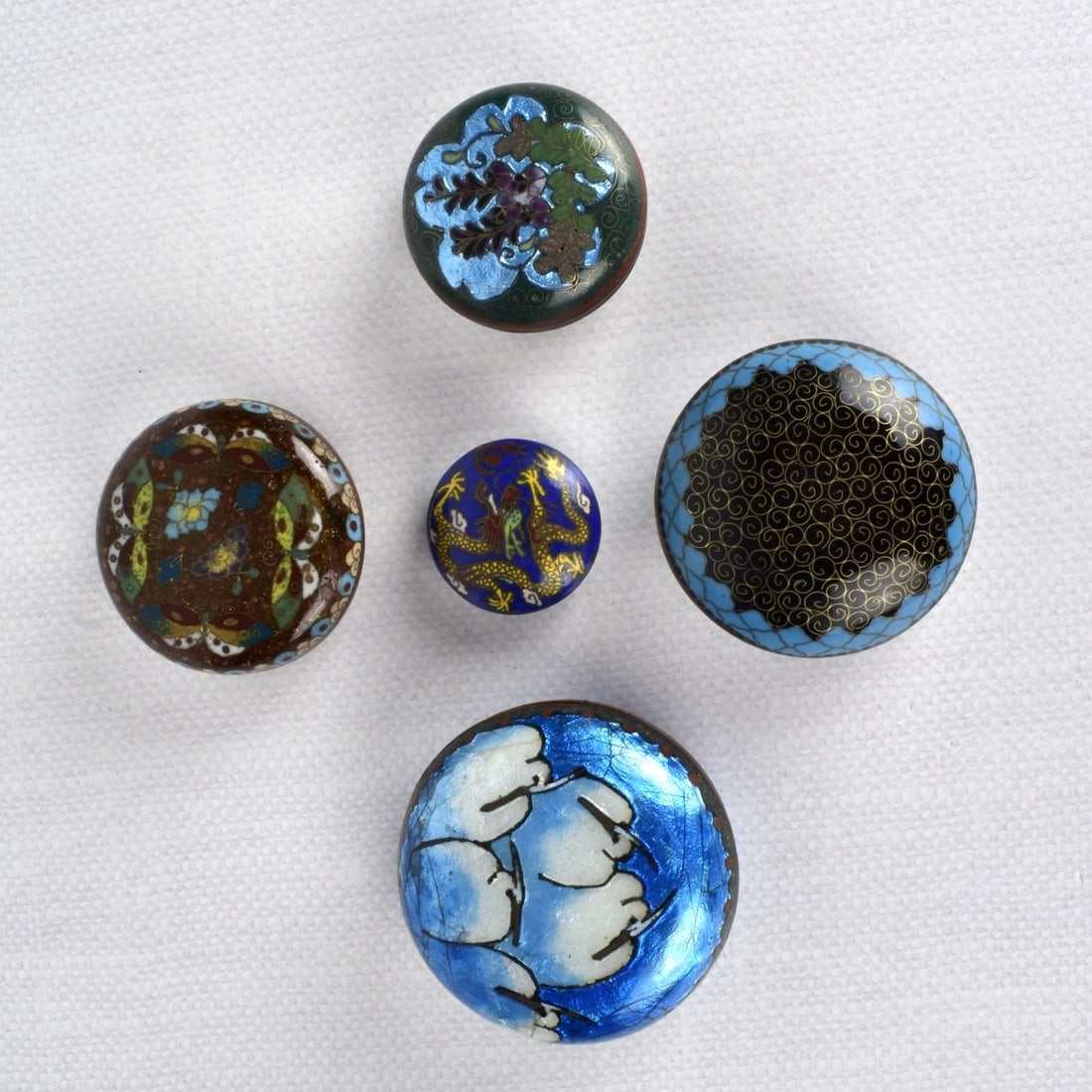 Japanese Cloisonne Pieces: Collection of Five (5) Japanese Meiji Period Pieces. Consisting of four (4) cloisonne lidded boxes and one (1) pendant. Largest box measures: 1-1/2" H, 3" Dia. Pendant measures: 1/2" H, 1-1/2" Dia. Ko