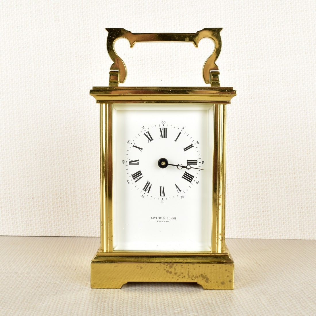 Taylor and Bligh English Carriage Clock: Taylor and Bligh English Brass Carriage Clock, Battery Operated. Overall 6" H, 3-1/4" W, 2-1/2" D. Kodner Galleries offers phone and absentee bidding at a low, flat 21% buyer?s premium without surchar
