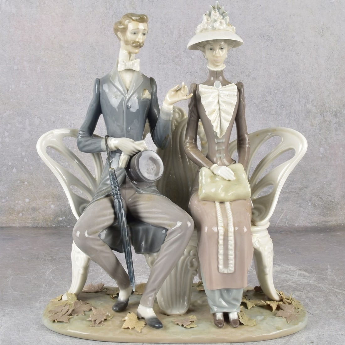 Lladro Spain Gloss Porcelain Sculpture: Lladro Spain Gloss Porcelain Sculpture. "Lovers in the Park" properly marked to the underside. Measures: 12" high, 10-1/2 " wide, 5-1/4" deep. Kodner Galleries offers phone and absentee bidding at a l