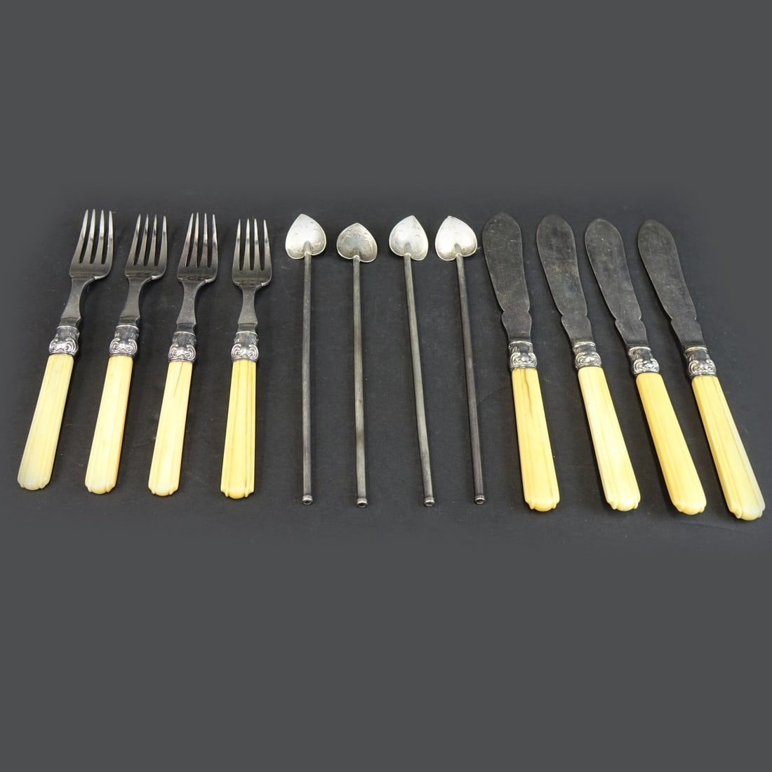 (12) Vintage Silverplate and Sterling Flatware: Lot of Twelve (12) Vintage Silverplate and Sterling Silver Tableware Flatware. Includes a 8 piece Silverplate fish set consisting of (4) knives and (4) forks along with (4) sterling silver ice tea spo