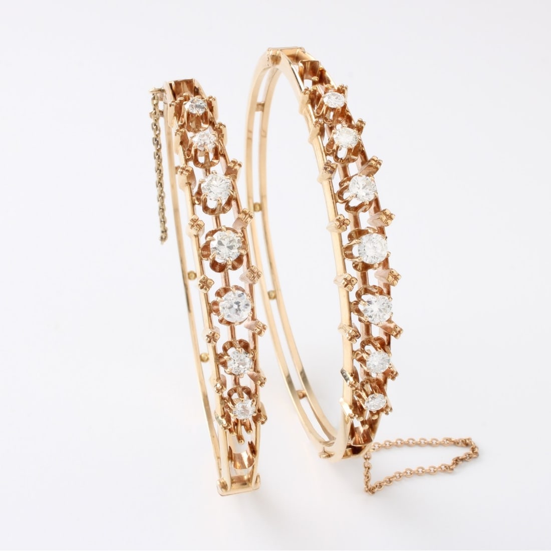 Diamond and 14K Bangle Bracelets: Pair of Vintage Approx. 3.50 Carat TW Fourteen (14) Graduated Round Brilliant Cut Diamond and 14 Karat Yellow Gold Hinged Bangle Bracelets. Diamonds G-H color, VS-SI clarity. Measure 7" interior circu