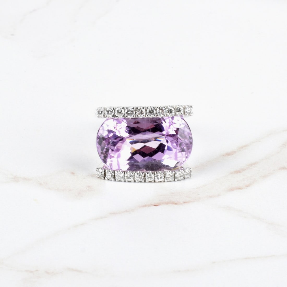 Kunzite, Diamond and 14K Ring: Large Oval Cut Gem Quality Kunzite, Approx. 1.0 Carat TW Twenty Round Brilliant Cut Diamonds and 14 Karat White Gold Cocktail Ring. Kunzite measures 22.30 x 17.0 x 12.0mm. Diamonds E-F color, VS1-VS2 
