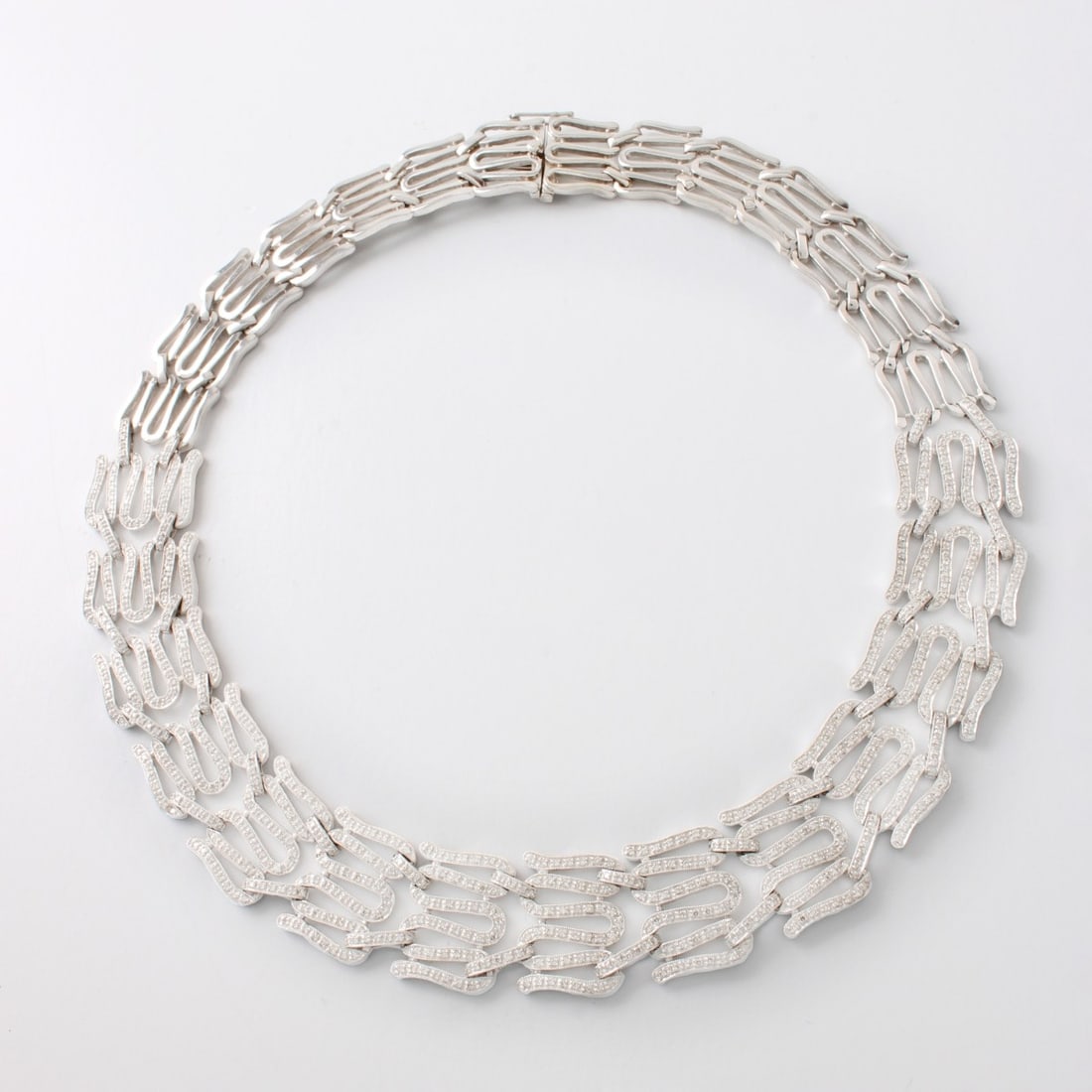 Diamond and 18K Necklace: Modern Design Approx. .6.95 Carat TW Pave Set Round Brilliant Cut Diamond and 18 Karat White Gold Necklace. Diamonds E-F color, VS clarity. Measures 16-1/2" L, 3/4" W. Approx. weight: 75.63 grams.