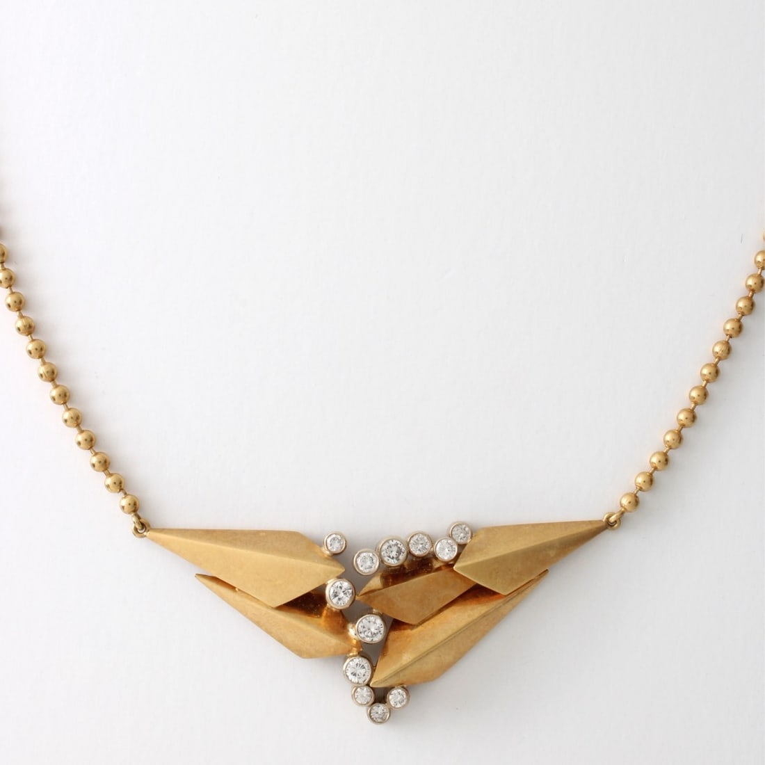 Wechler Diamond and 18K Necklace: Vintage Modern Wechler Signed Approx. 1.0 Carat TW Twelve Bezel Set Round Brilliant Cut Diamond and 18 Karat Yellow Gold Pendant Necklace. Diamonds E-F color, VS1-VS2 clarity. Stamped 18K. Measures 15