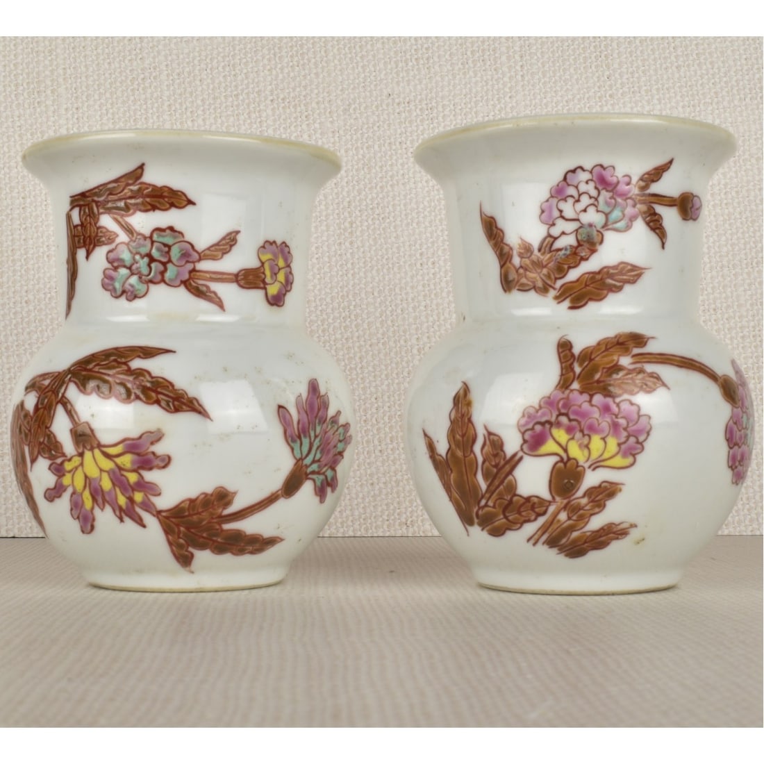 Chinese Porcelain Vases: Pair of Chinese Daoguang style Famille Rose Porcelain Vases. Reign marks to bases. Measures 4" H, 3-1/8" W. Kodner Galleries offers phone and absentee bidding at a low, flat 21% buyer?s premium
