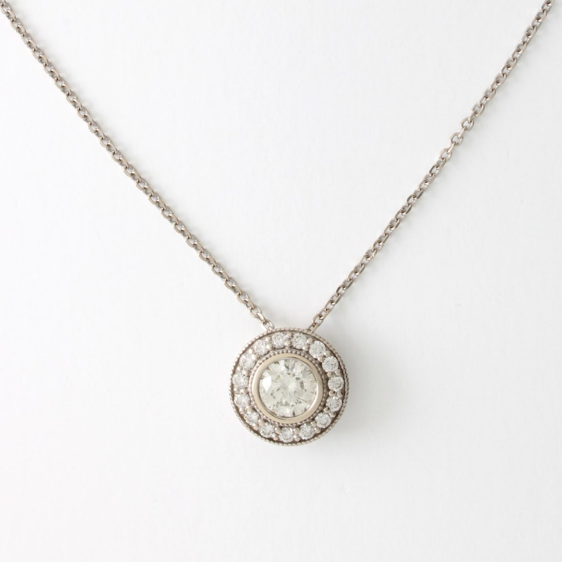 Diamond and 14K Necklace: Diamond and 14 Karat White Gold Pendant Necklace. Set in the center with an approx. 1.20 carat round brilliant cut diamond measuring 7.0 x 4.0mm, H-I color, SI1 clarity. Accented with approx. .50 cara