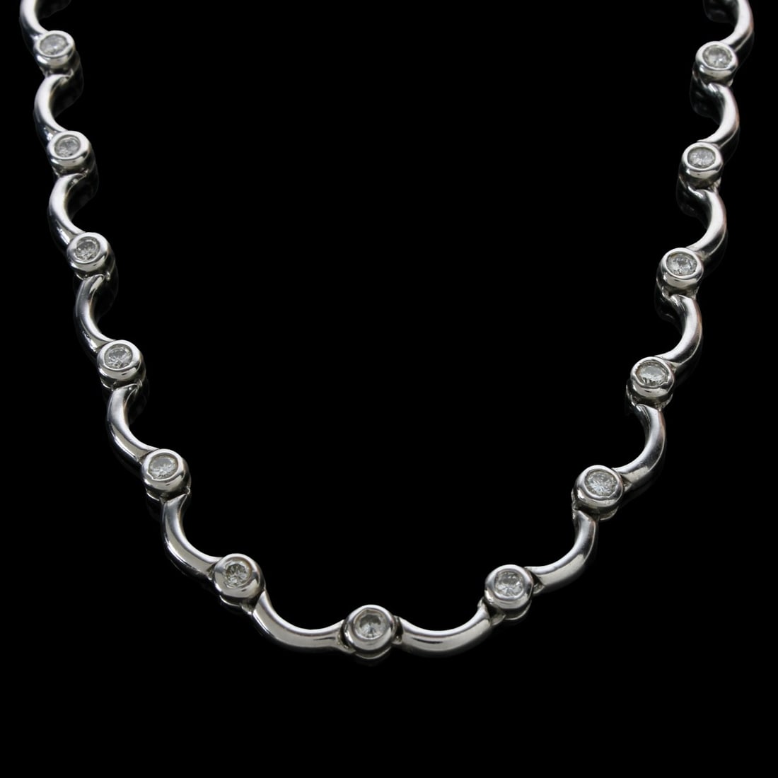 Diamond and 14K Necklace: Contemporary Design Approx. 3.50 Carat TW Thirty-five Round Brilliant Cut Diamond and 14 Karat White Gold Scallop Link Necklace. Diamonds H color, VS1 clarity. Clasp stamped 14K. Measures 17-1/2" L. A