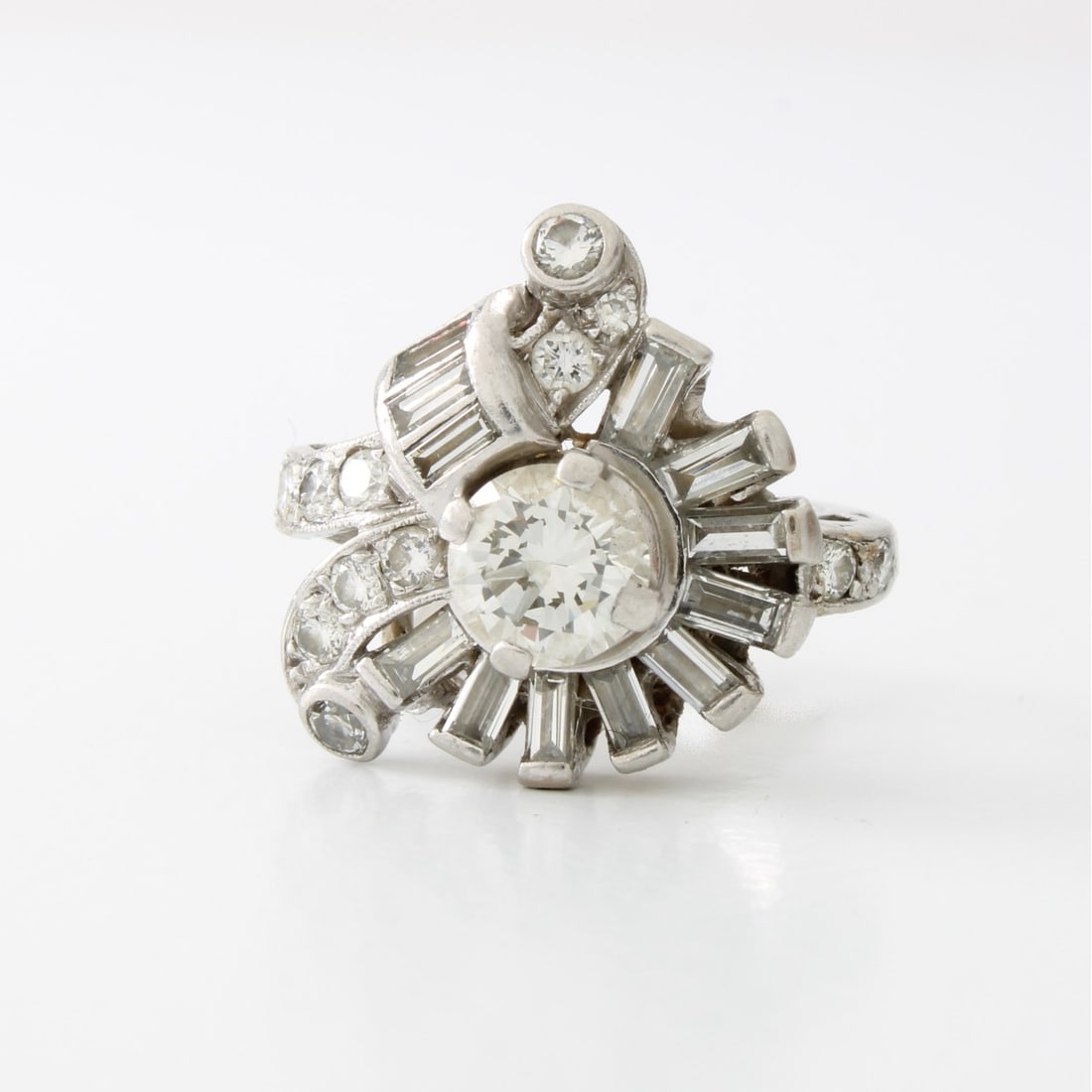 Diamond and Platinum Ring: Vintage Circa 1940s Diamond and Platinum Cluster Ring. Set in the center with an approx. .82 carat round brilliant cut diamond, F-G color, VS1-VS1 clarity, measuring 6.1 x 3.6mm. Accented with approx.