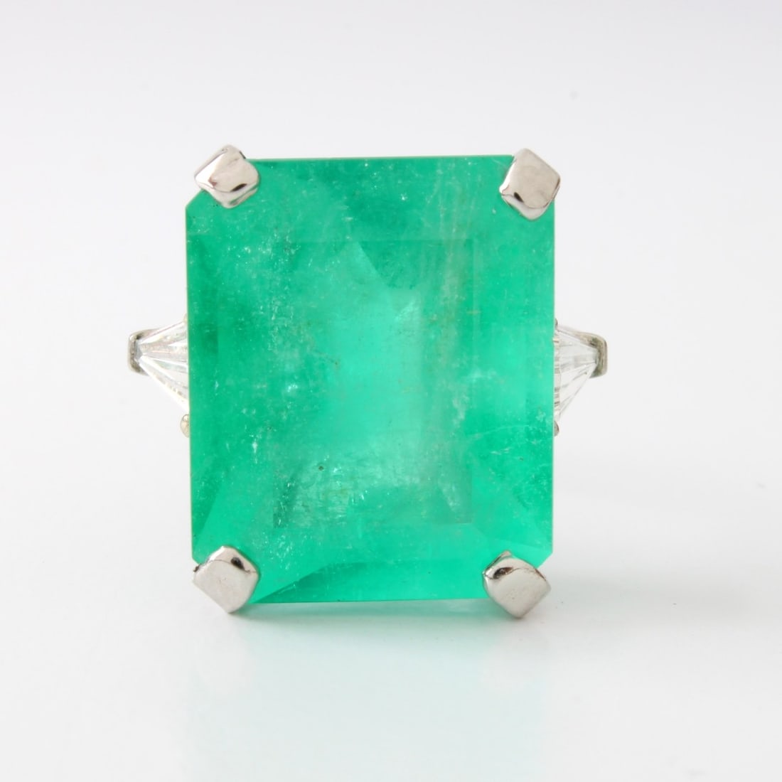 GIA Emerald, Diamond and Plat. Ring: Antique GIA Certified 17.61 Carat Colombian Emerald, Approx. 1.20 Carat TW Two Tapered Baguette Cut Diamonds and Platinum Ring. Emerald with good color. Diamonds F color, VS1 clarity. Ring stamped Pla