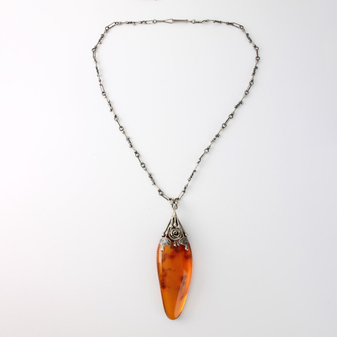 Art Nouveau Amber & Silver Necklace: Art Nouveau Huge Amber and Silver Pendant Necklace. Amber measures 3-1/4" L, 1-1/4" W. Necklace measures 25" L, 4-1/8" pendant drop. Approx. total weight: 54,25 grams. Kodner Galleries offers phone an