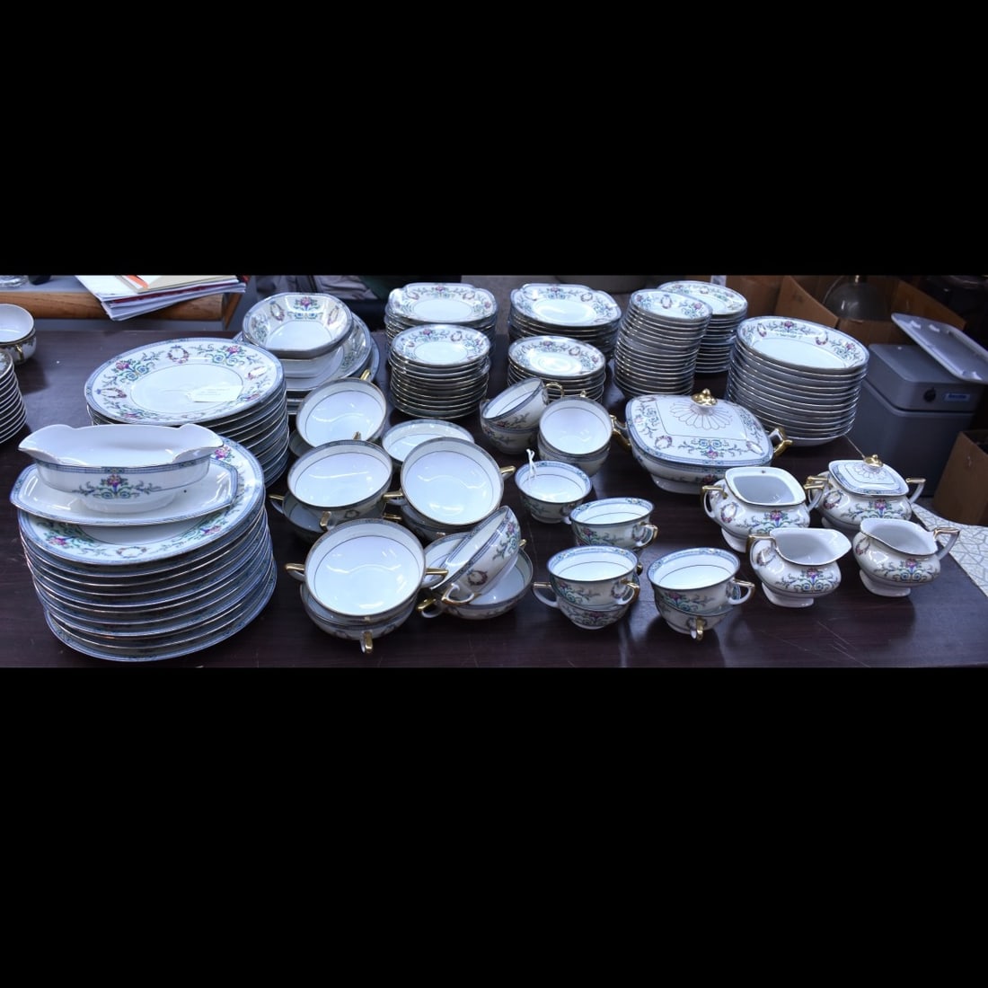 Porcelain Union Dinner Service: One Hundred and Forty Four (144) Piece Porcelain Union "Pun 2" Porcelain Dinner Service. Signed. Includes: (23) dinner plates measuring 9-3/4", (20) salad square plates measuring 7-5/8", (13) soup