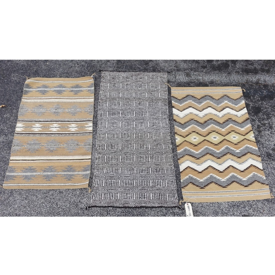 Three Navajo Saddle Blankets: Three (3) Vintage Navajo Saddle Blankets. Geometric patterns on surface. Size: 29-3/4" x 46-3/4", 27-3/4" x 55-34" , 28-3/4" x 45-1/2". Kodner Galleries offers phone and absentee bidding at a low,