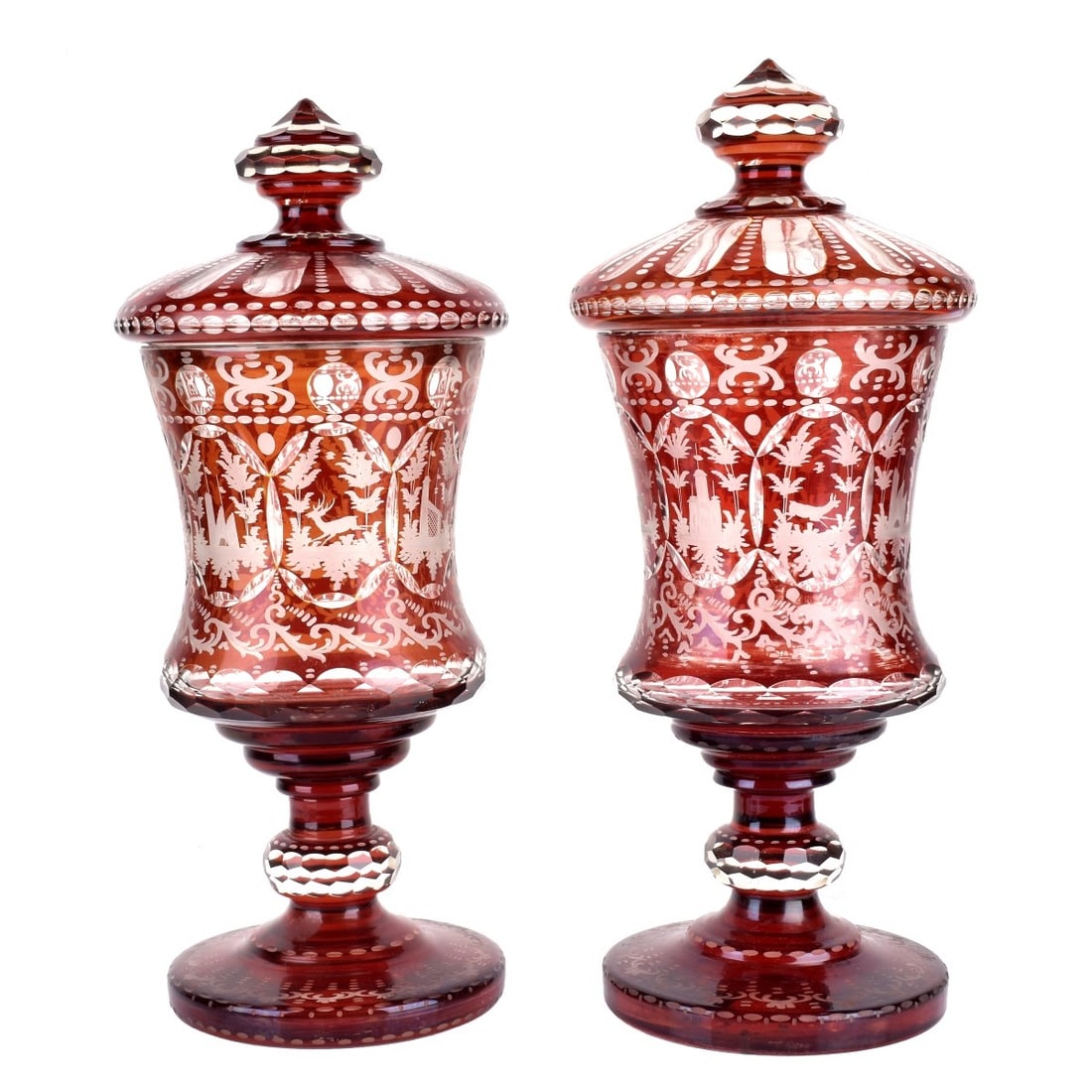 Bohemian Cranberry Vases: Pair of Fine19th Century Bohemian Cranberry Cut to Clear Vases with Covers. Stag and foliage motif, polished pontil base. Measures 18" H x 8" Diameter. Kodner Galleries offers phone and absentee biddi