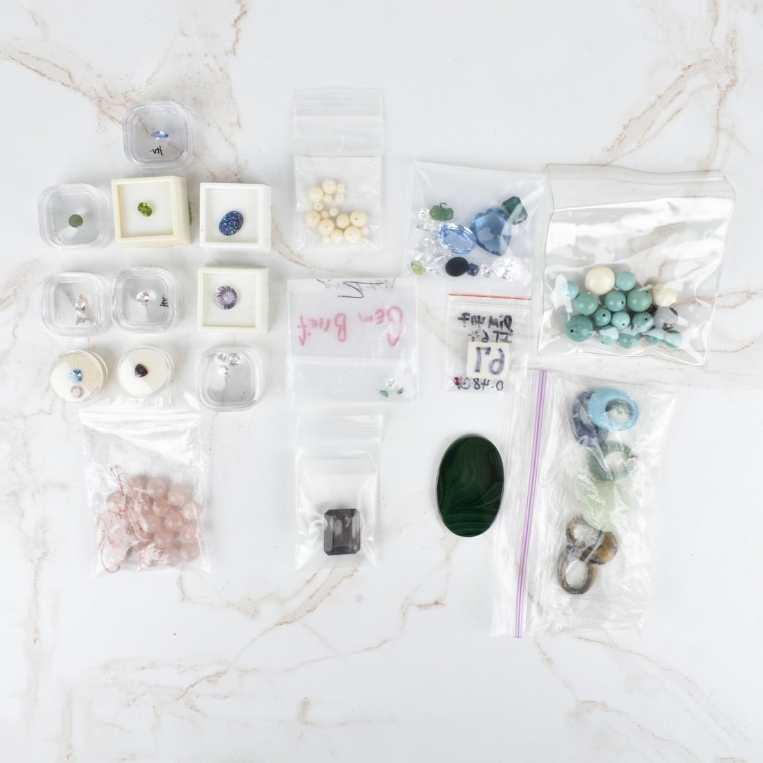 Large Lot of Hard Stone and Gem Stones: Large Lot of Hard Stone and Gem Stones. Including cubic zirconian, smoky quartz, Peridot, amethyst malachite, assorted beads and others. Kodner Galleries offers phone and absentee bidding at a low, fl
