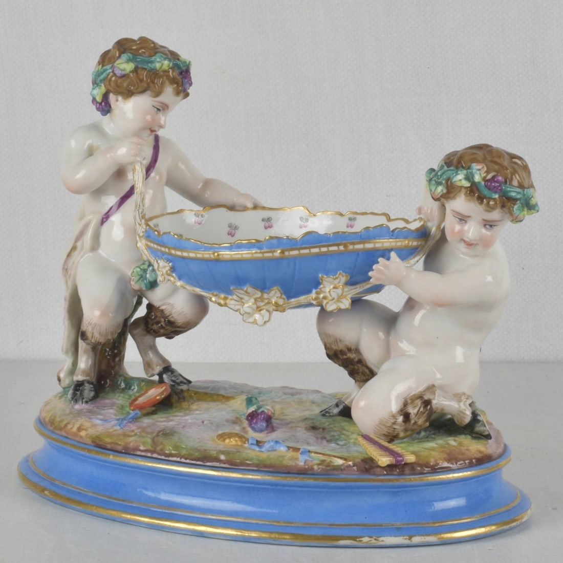 Henri Ardant & Co. Porcelai: Henri Ardant & Co. Porcelain Young Satyr Centerpiece Bowl. Late 19th century. Properly marked to the bottom. Measures: 9-3/4" high, 11" wide, 5-1/2" deep. Kodner Galleries offers phone and absentee
