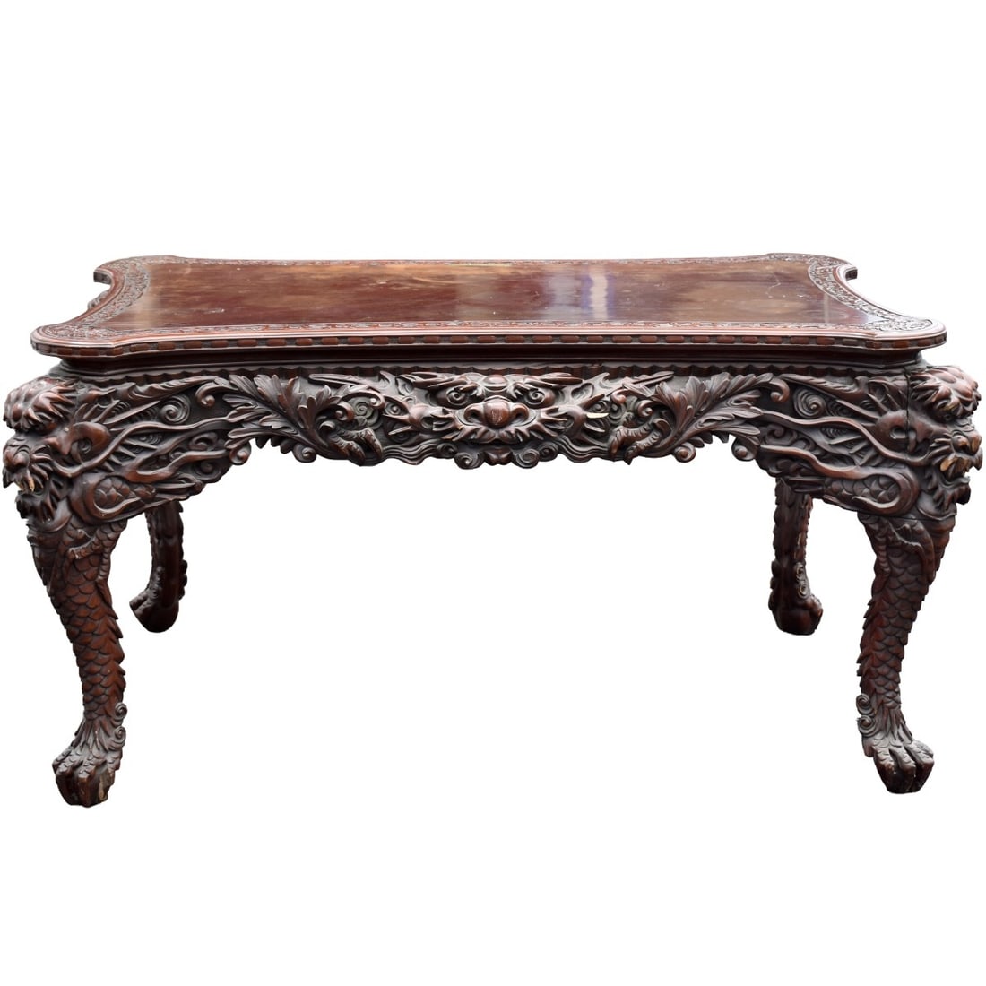 Carved Chinese Table: Antique Carved Chinese Table with a Floral Carved Apron. Measures: 29-1/2" high, 54" long, 36" deep. Kodner Galleries offers phone and absentee bidding at a low, flat 21% buyer?s premium without