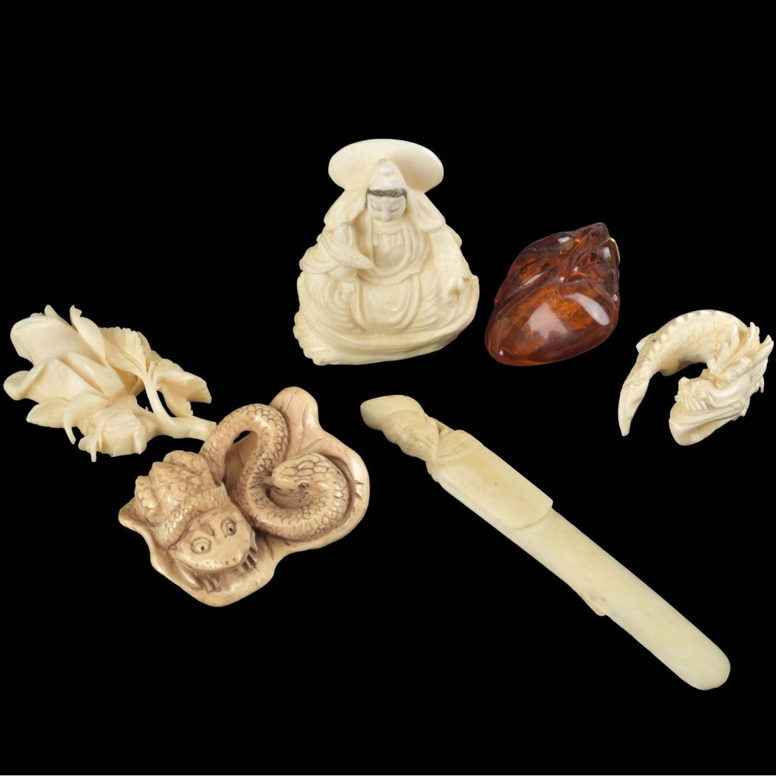 Collection of Japanese Carved Items: Collection of Six (6) Japanese Carved Items. One (1) amber pendant measures: 2" long, one (1) figural page marker, measures: 3-3/4" long, along with three (3) other carved items. We Will Not Ship